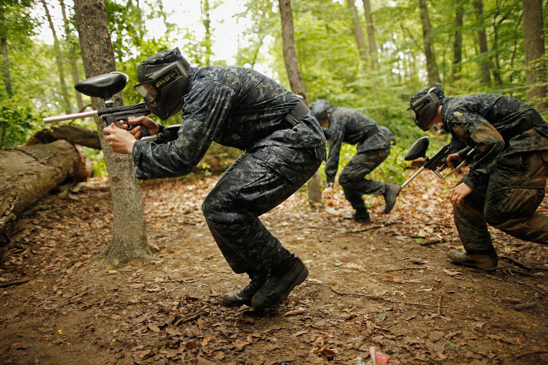 Men In Camouflage Gear Playing Paintball Wallpaper