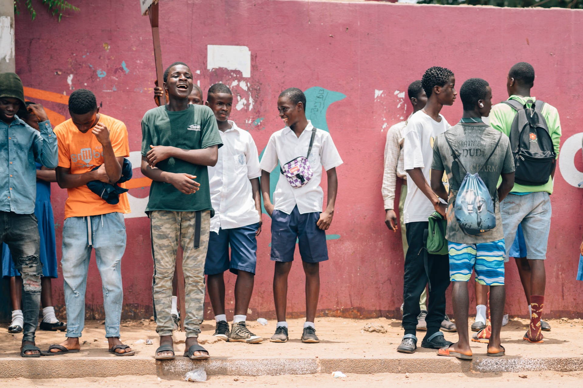 Men In Sierra Leone Waiting By Wall Wallpaper