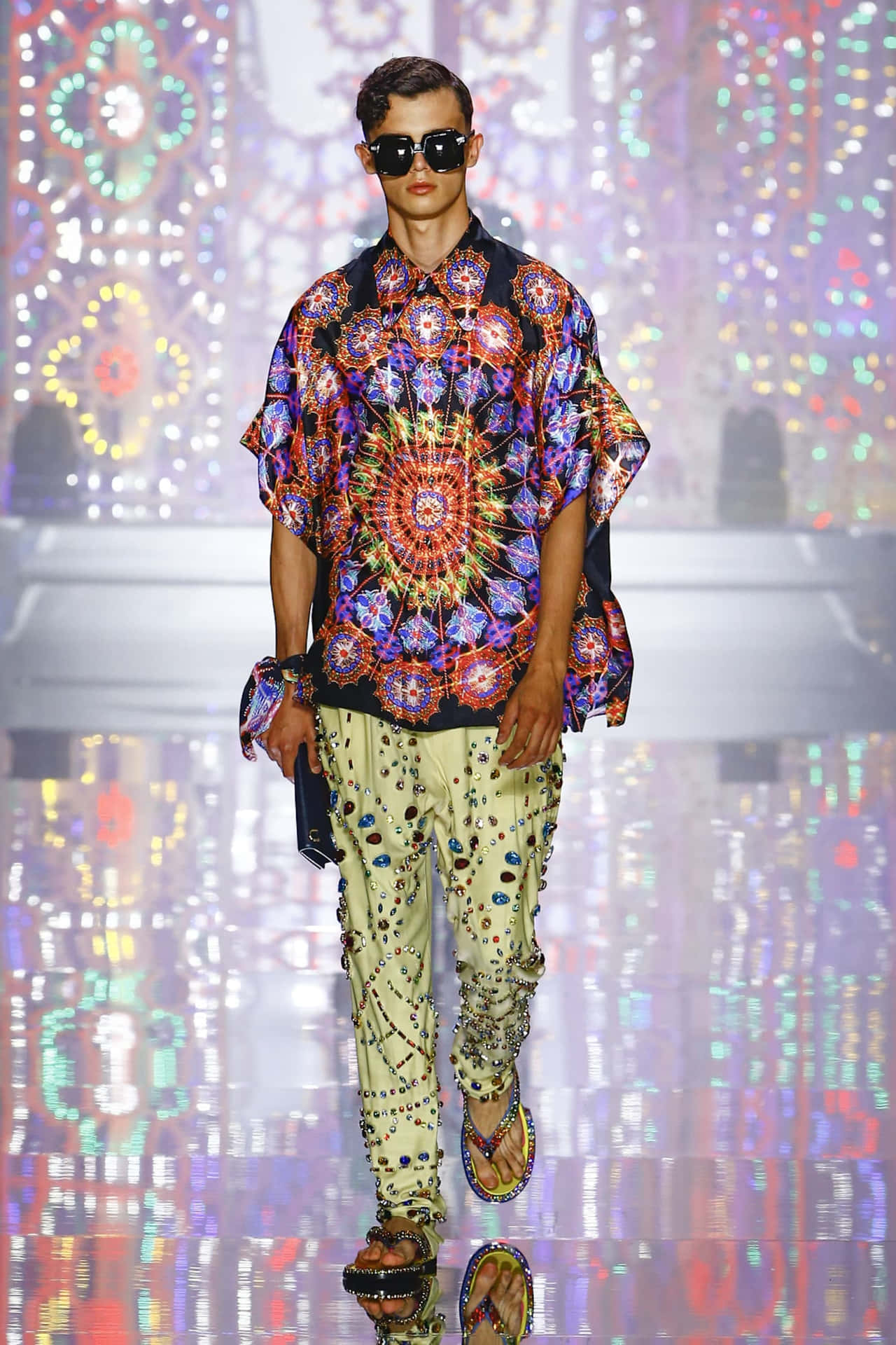 A Man Wearing A Colorful Shirt And Pants On The Runway