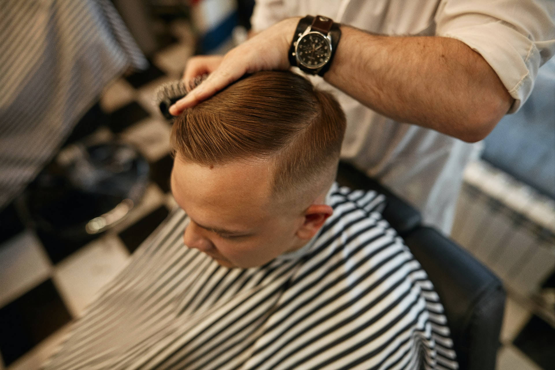 Caption: Stylish Sleek Side Part Men's Haircut Wallpaper