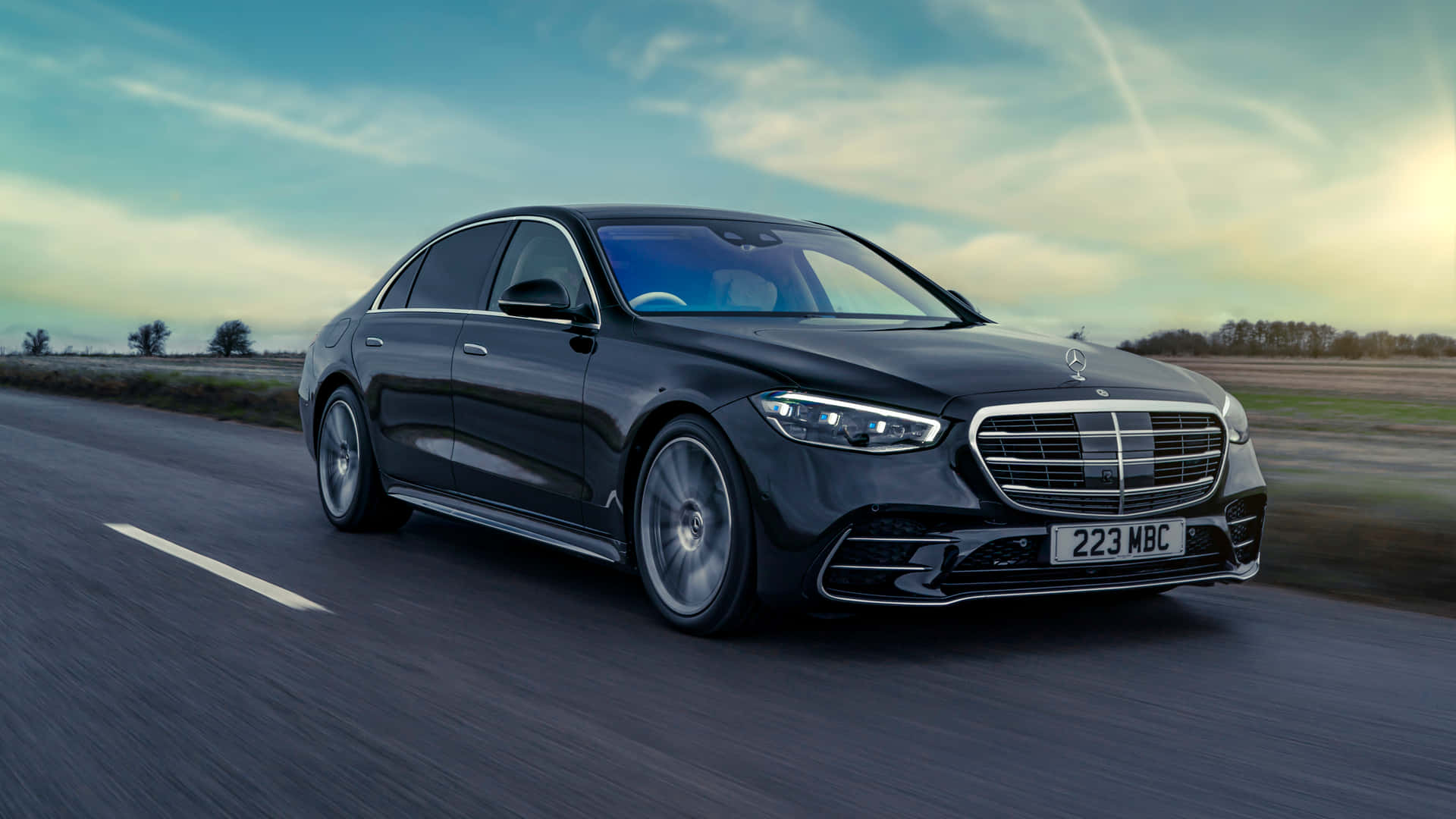 The Mercedes S Class Is Driving Down The Road Wallpaper