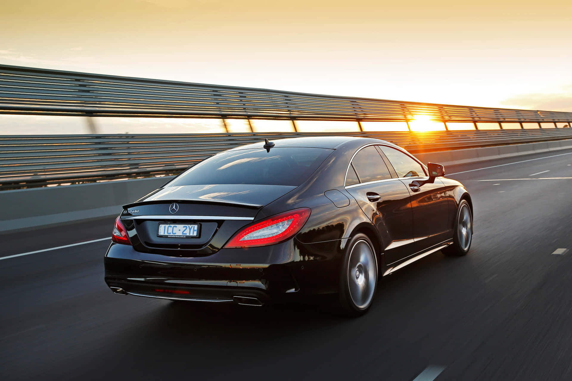Stunning Mercedes Benz CLS-Class in motion on a scenic road Wallpaper