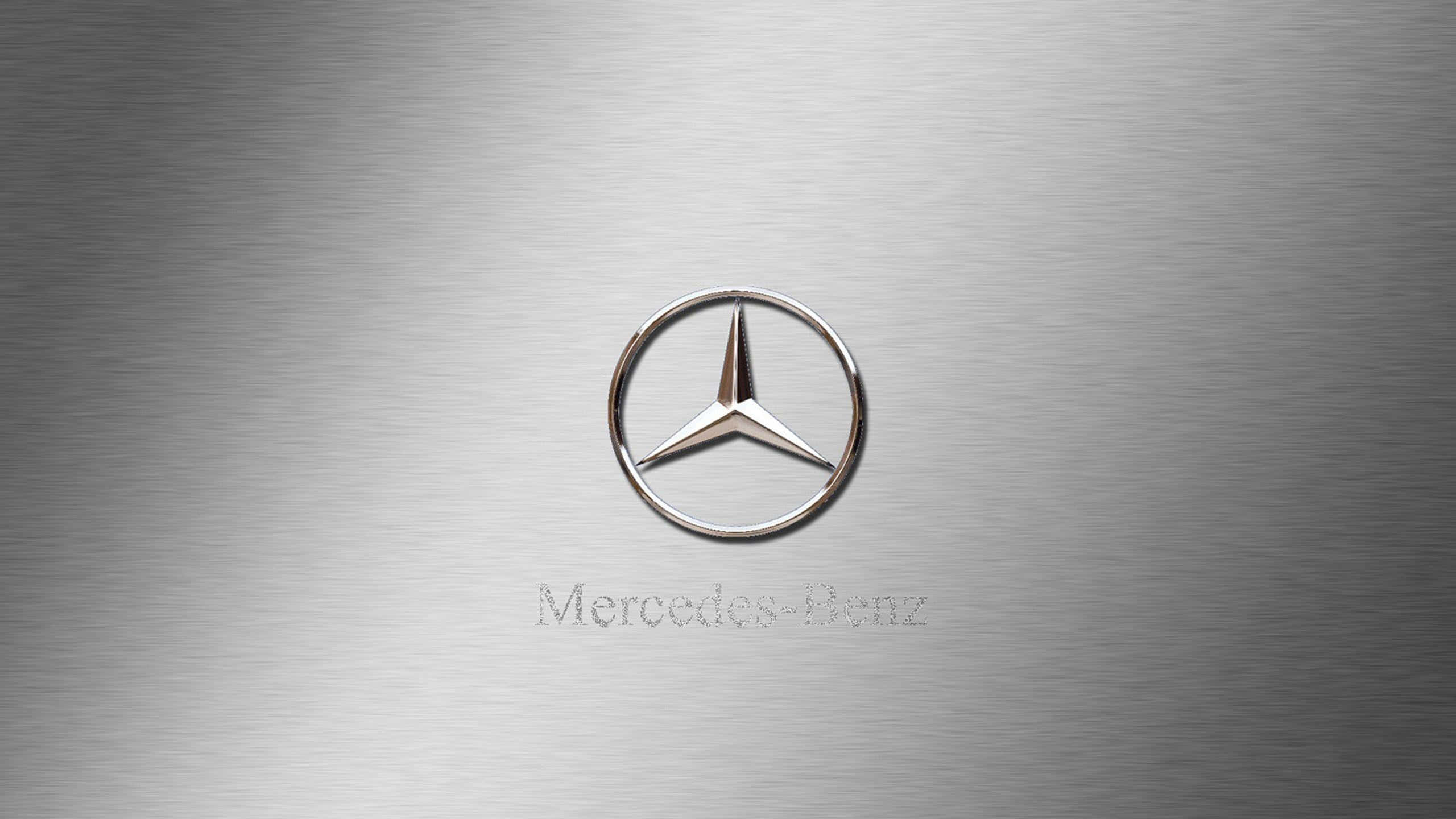 The iconic Mercedes Benz logo on black and silver