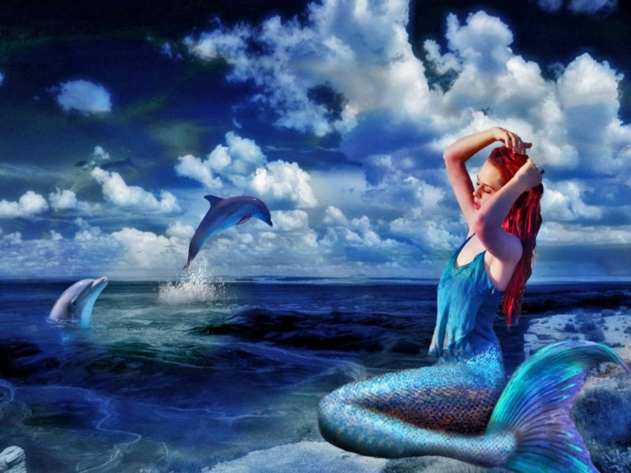 A mystical mermaid rises from the ocean depths Wallpaper