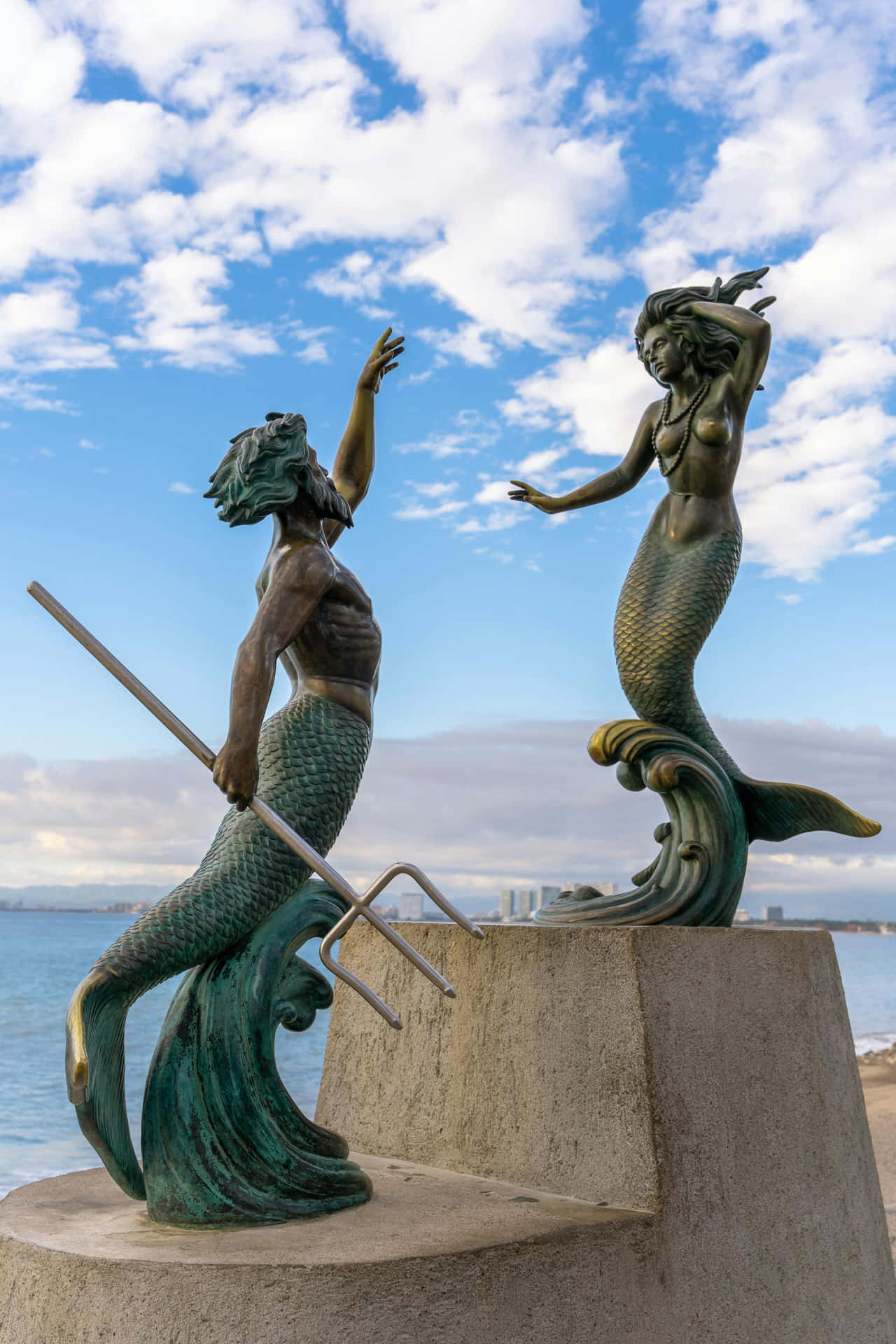 Mermaid Statues Greeting Sky Wallpaper