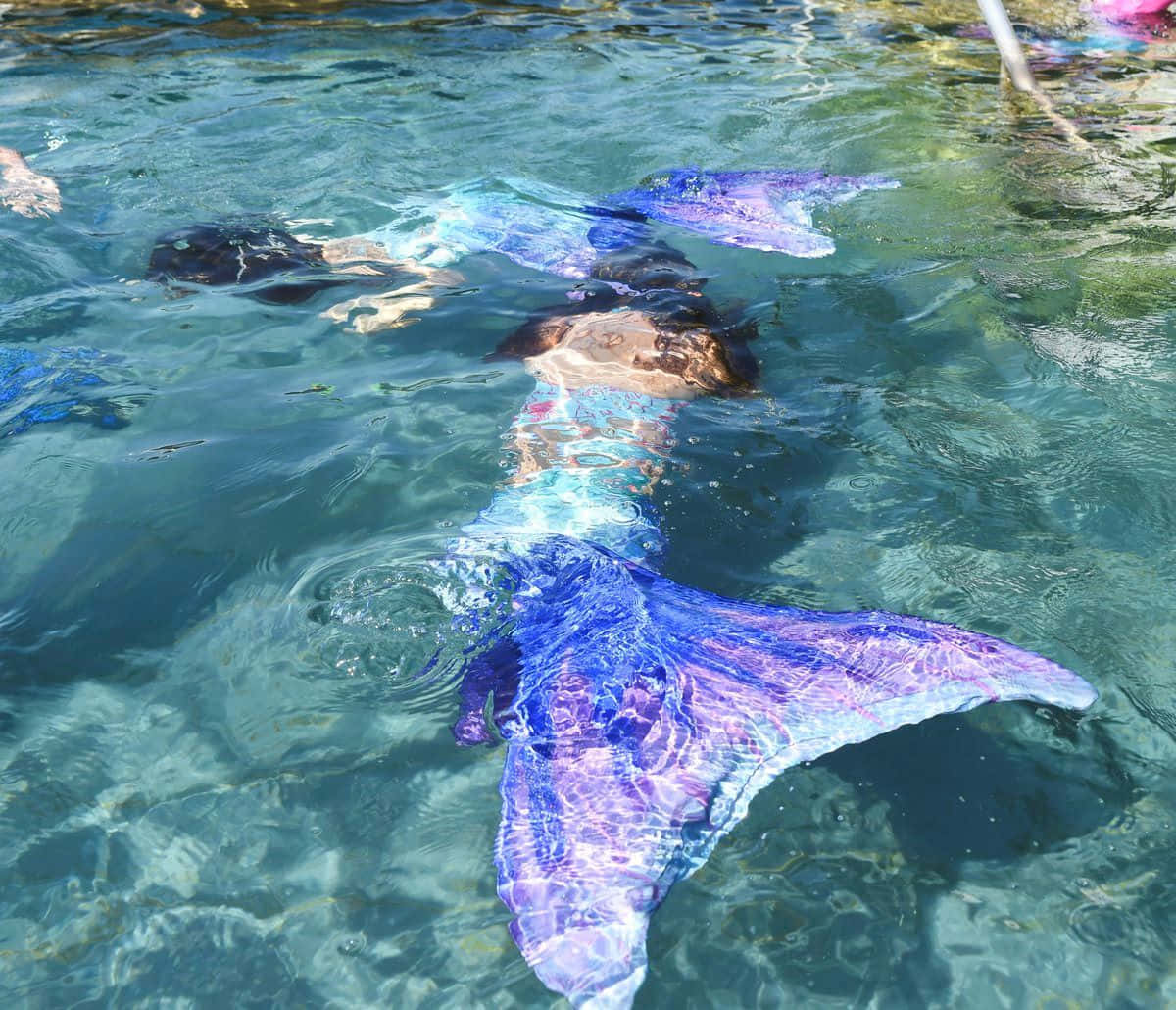 Mermaid Tail Swimmingin Crystal Waters Wallpaper