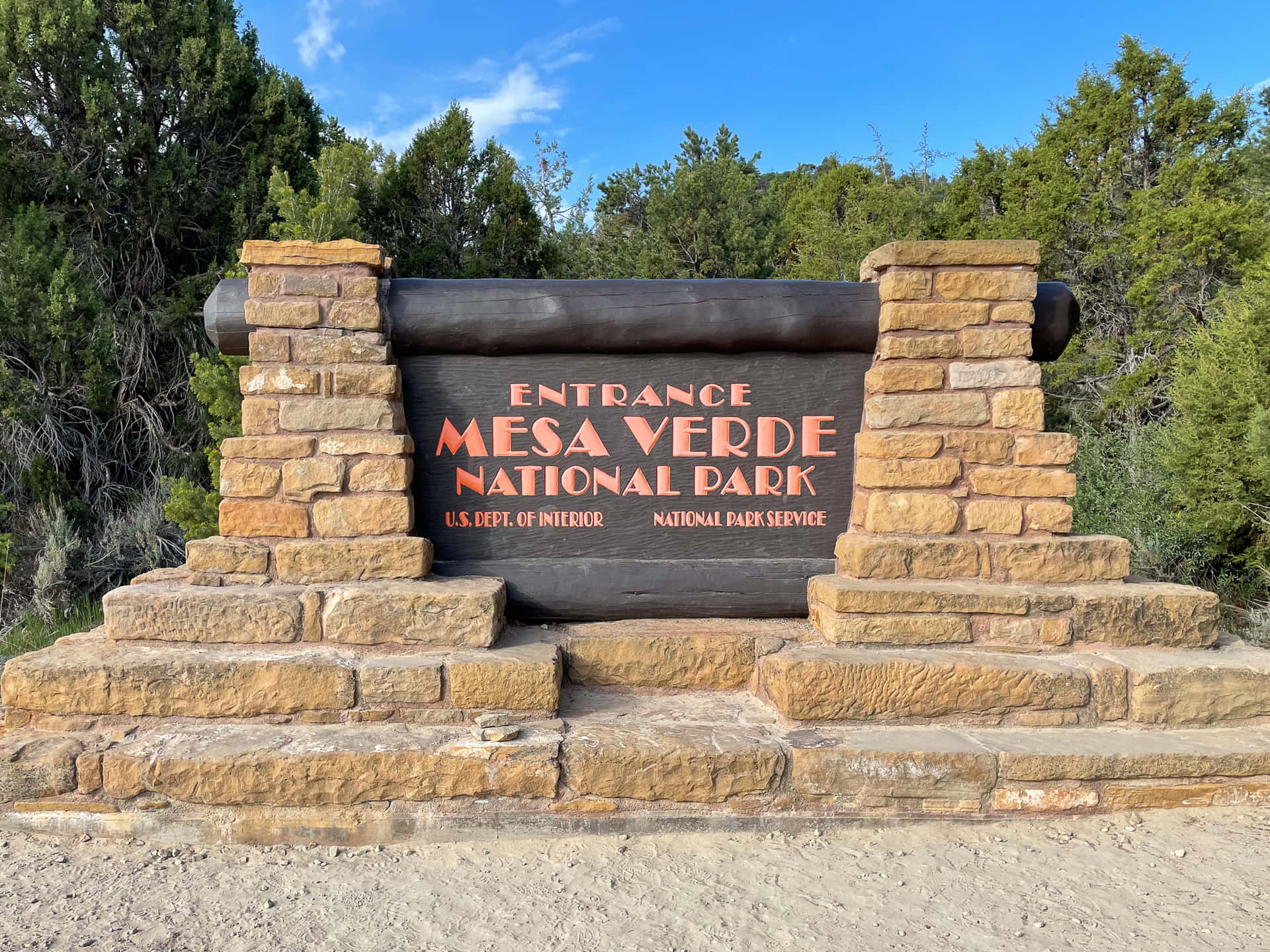 Mesa Verde National Park Entrance Sign Surrounded By Trees Wallpaper