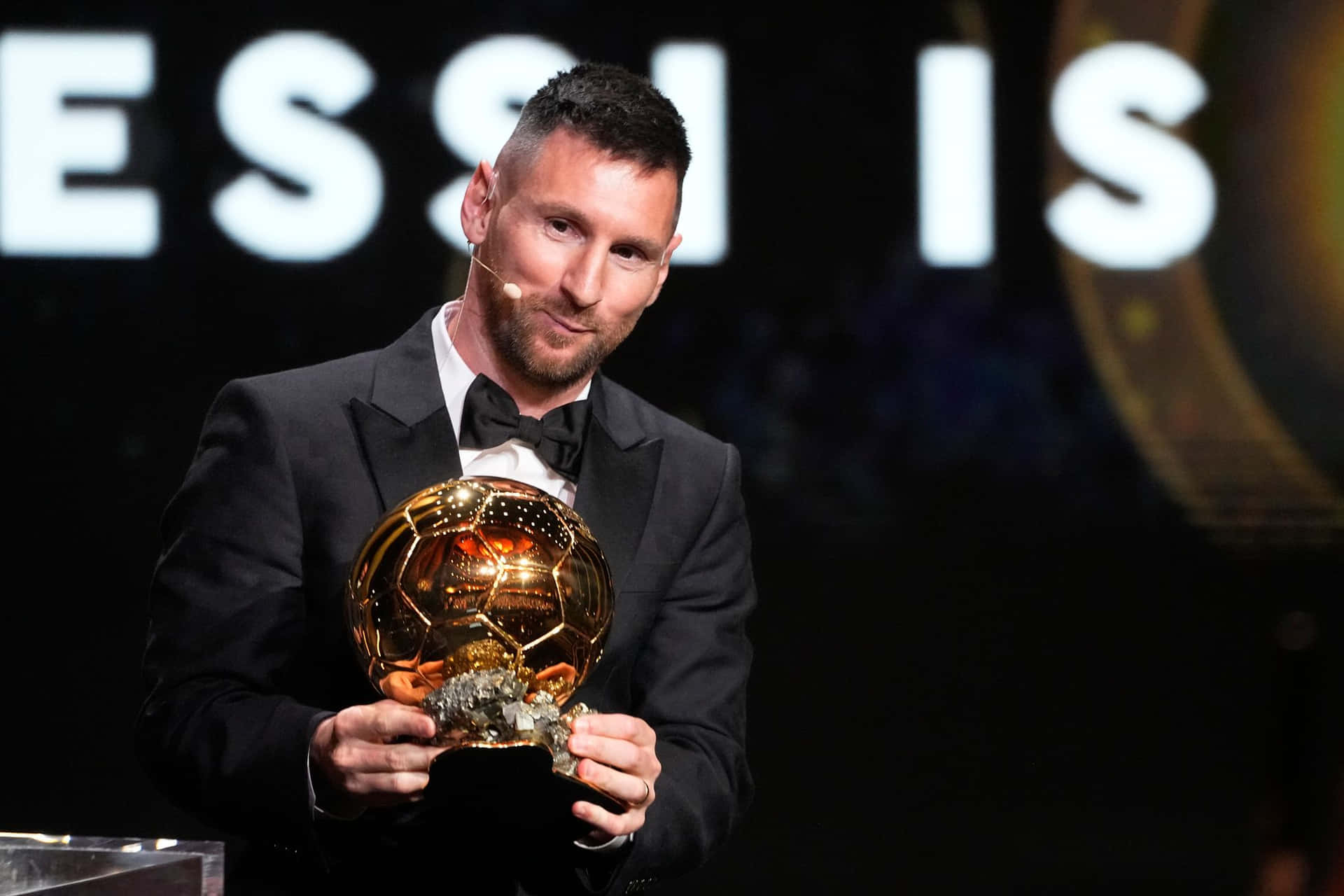 Messi Holding Ballond Or Award Wallpaper