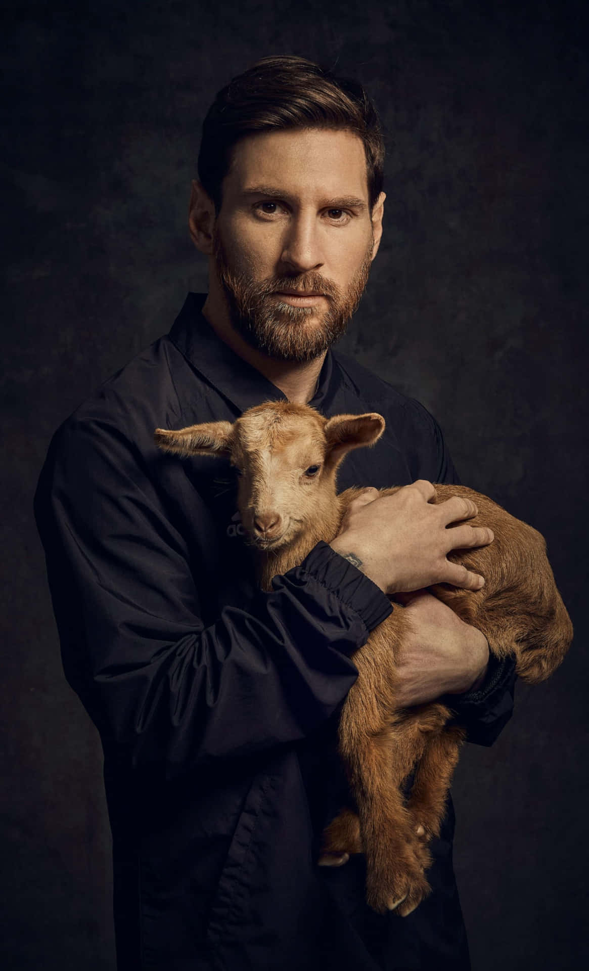 Messi Holding Goat Portrait Wallpaper