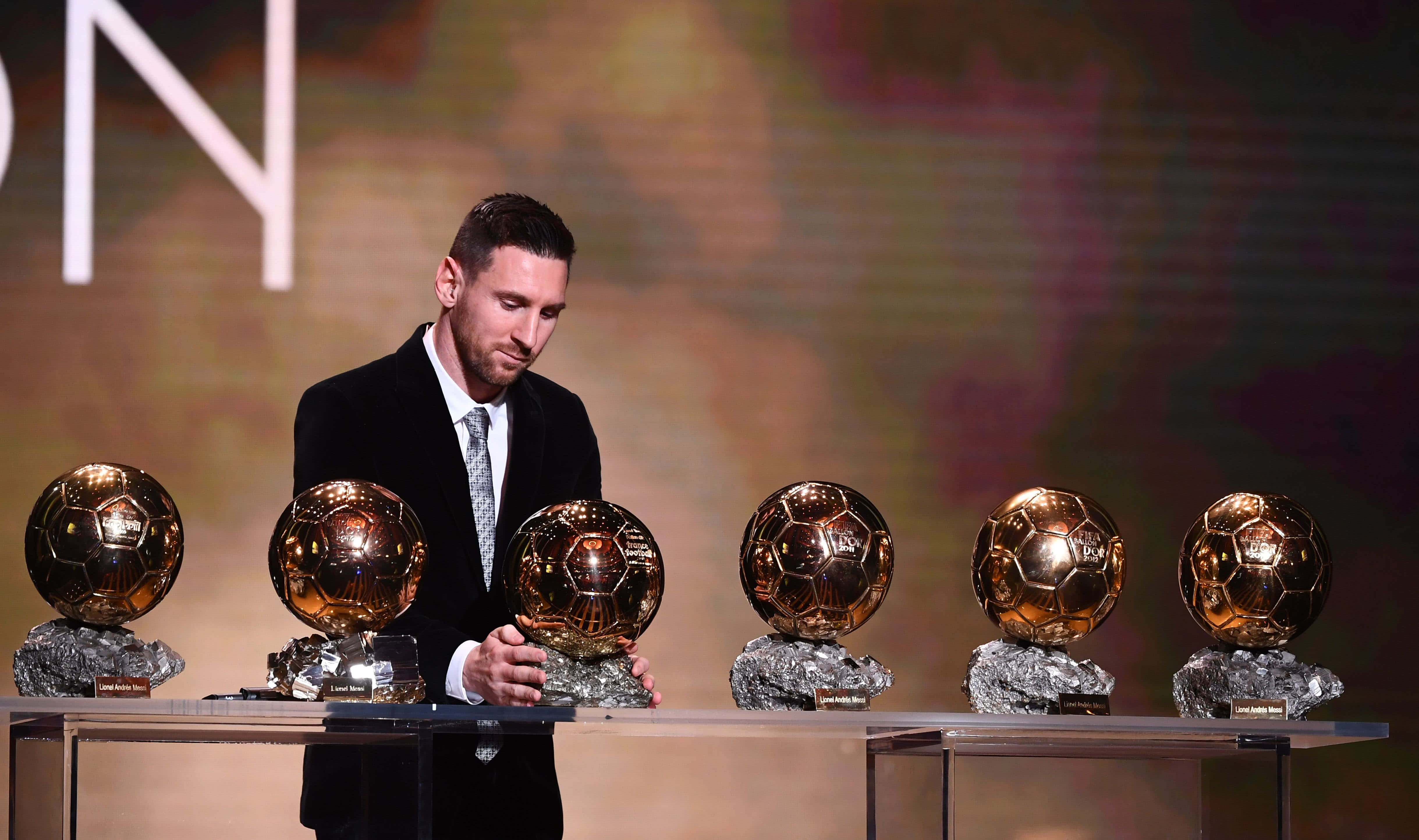 Messi Lifts The Ballon D'or Trophy Wallpaper