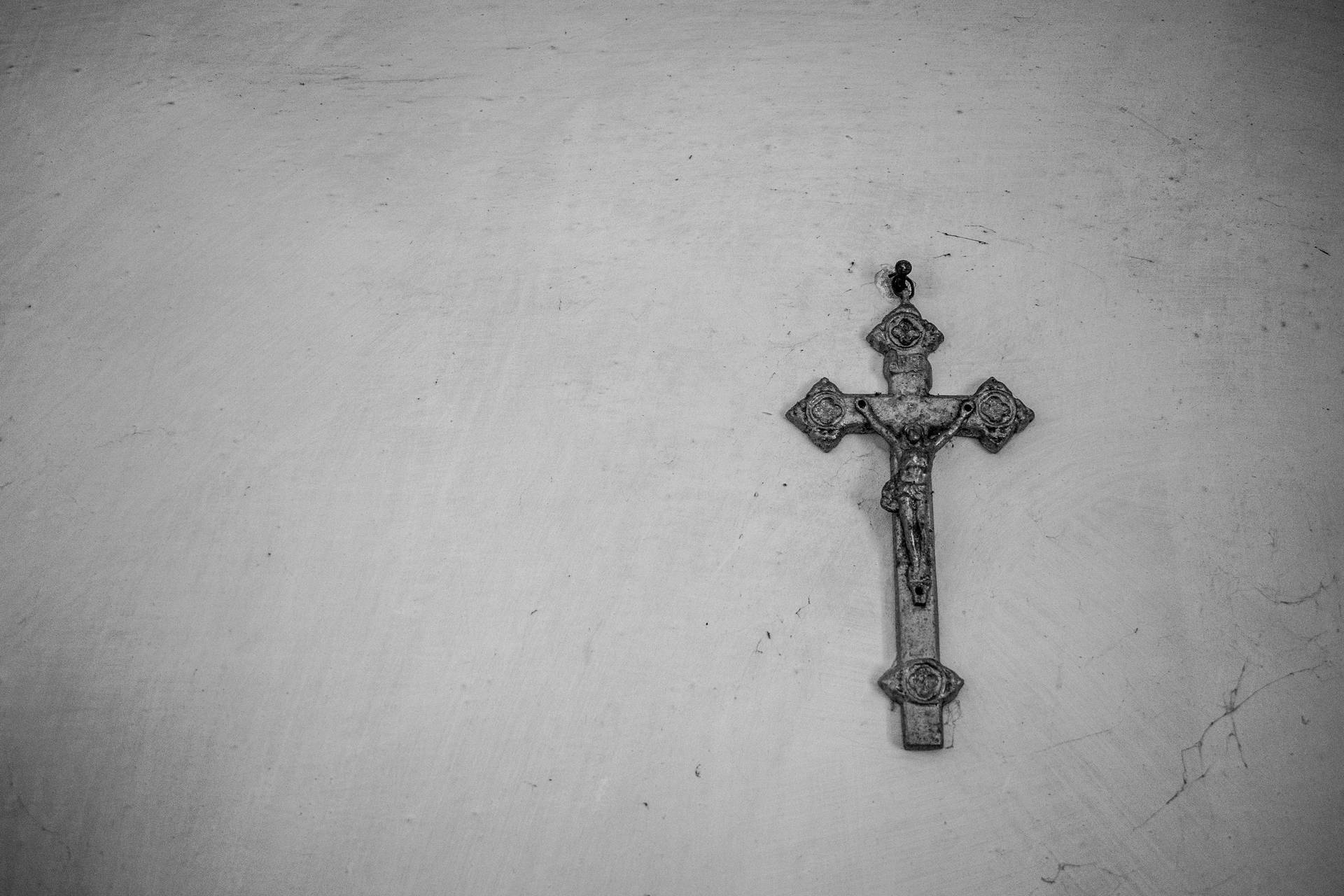 Metallic Jesus On Cross On A Wall Wallpaper