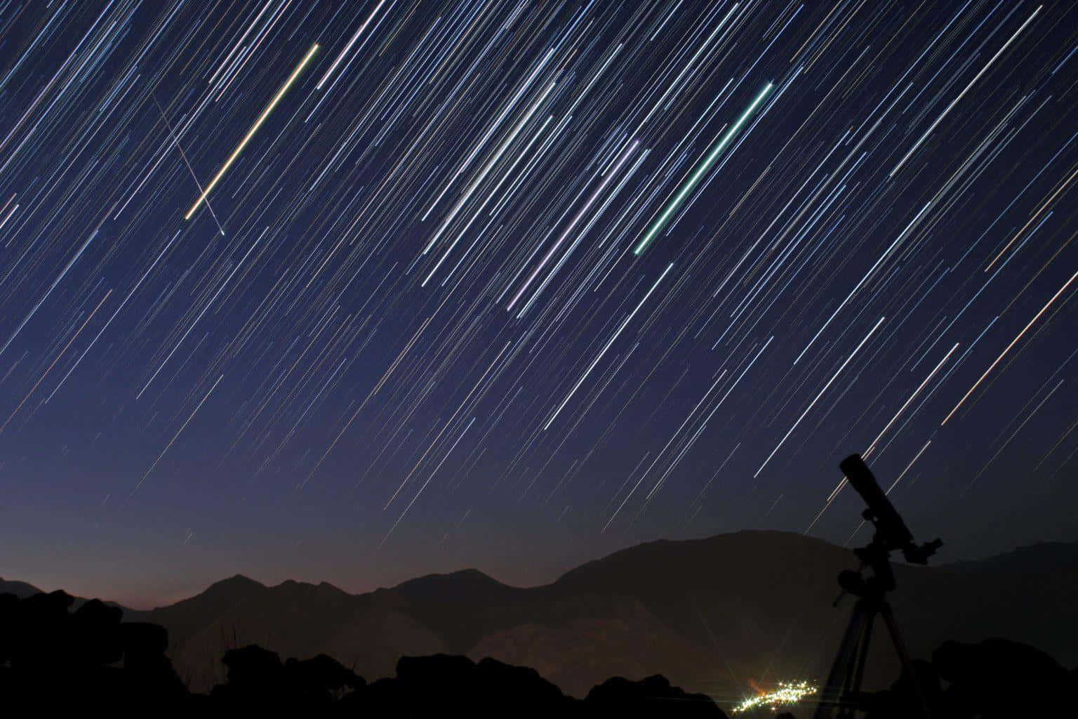 Stunning Meteor Shower in Night Sky Wallpaper