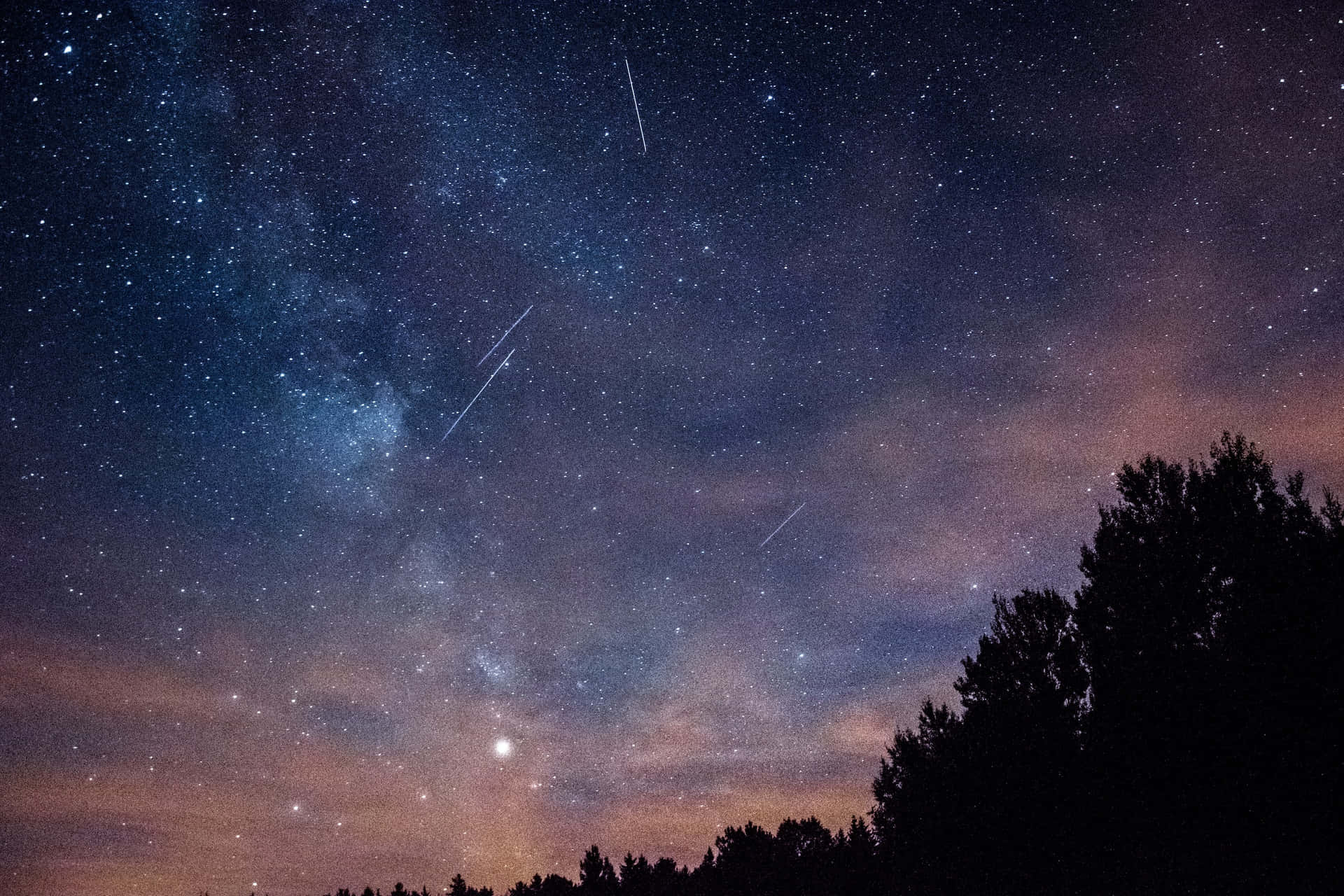 Captivating Meteor Shower in a Starry Night Sky Wallpaper