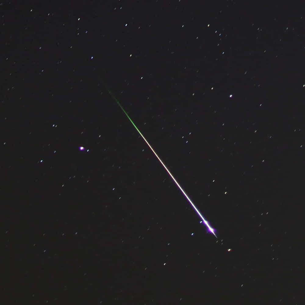 Image  Bright Meteor Streaking Across Dark Sky