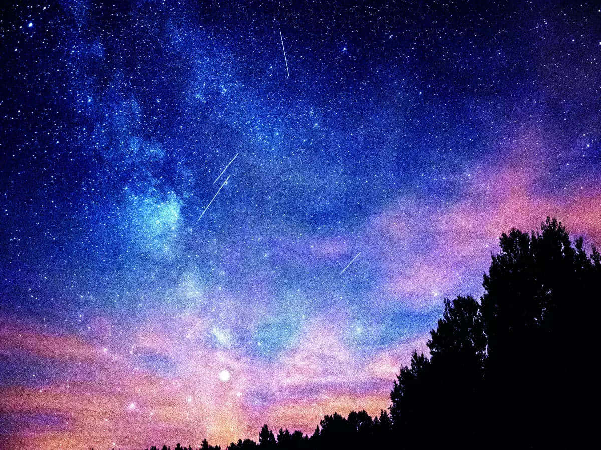 A glowing meteor streaks across the night sky.