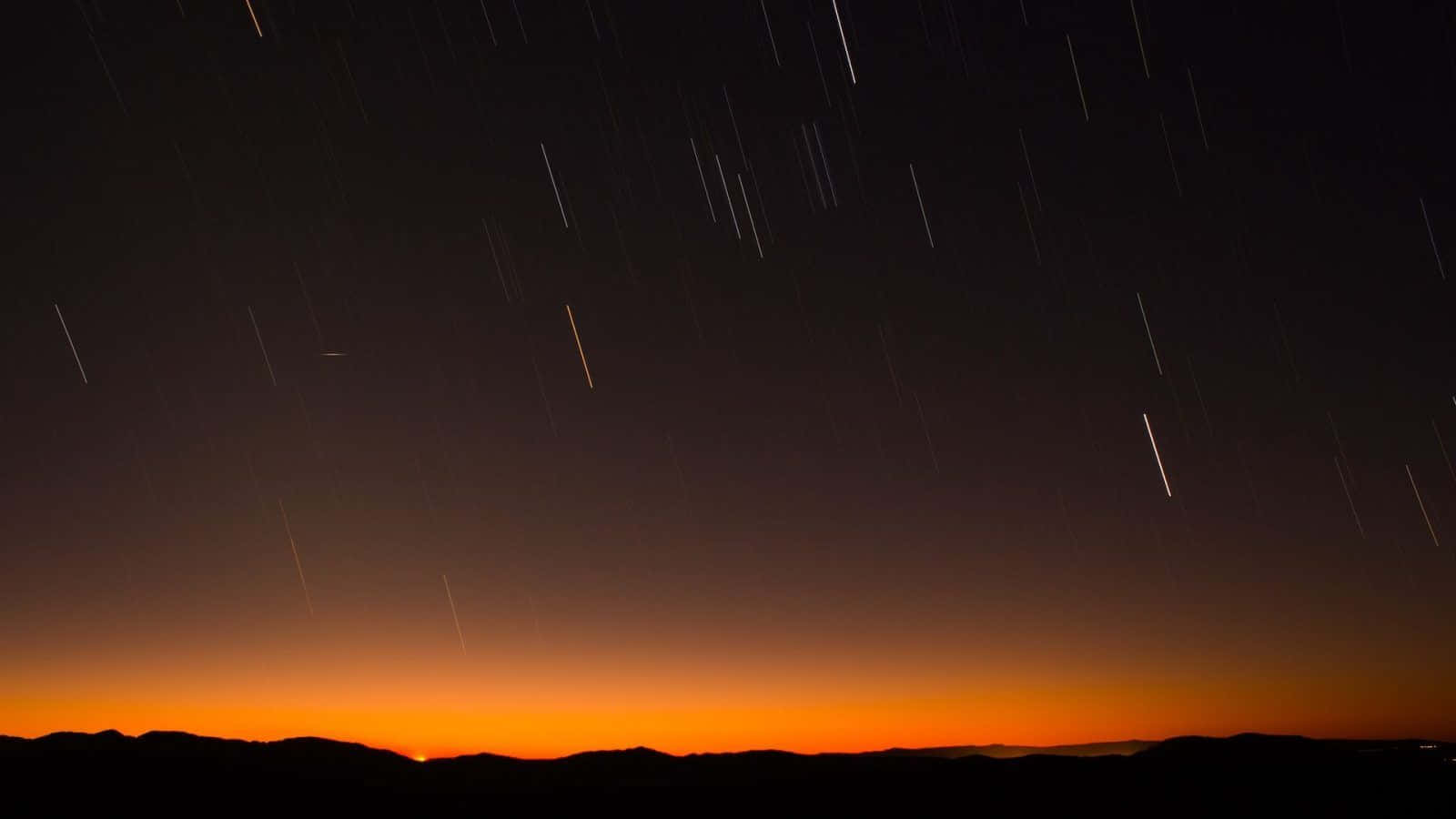 A meteor streaks across the night sky
