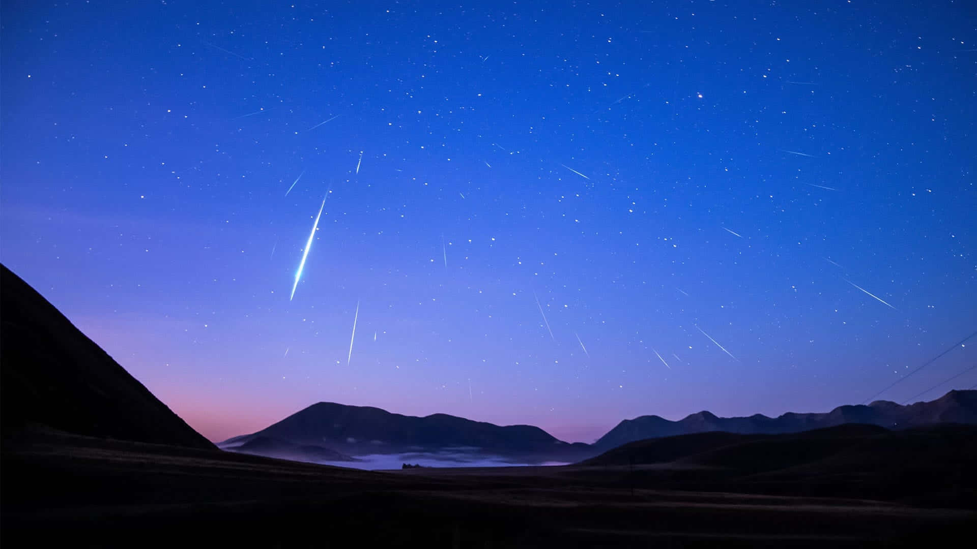 A beautiful nighttime view of a Meteor blazing across the night sky.