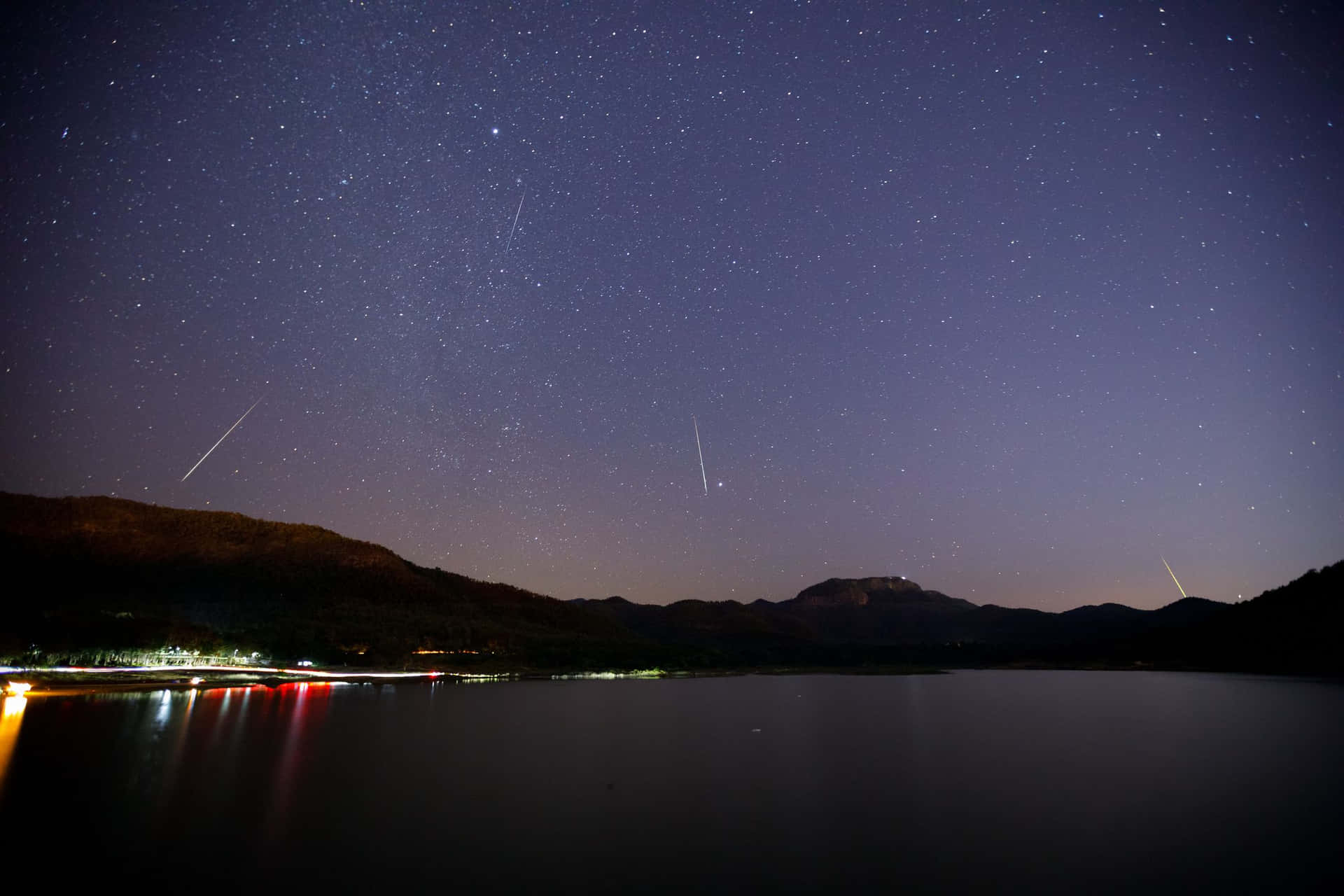 A blazing meteor streaks across the night sky | Description: A brilliant, colorful meteor streaks across a starry night sky. Its fiery tail trails behind it, creating a dazzling spectacle of light. | Keywords: Meteor, Celestial, Space, Stardust, Astronomy, Night Sky