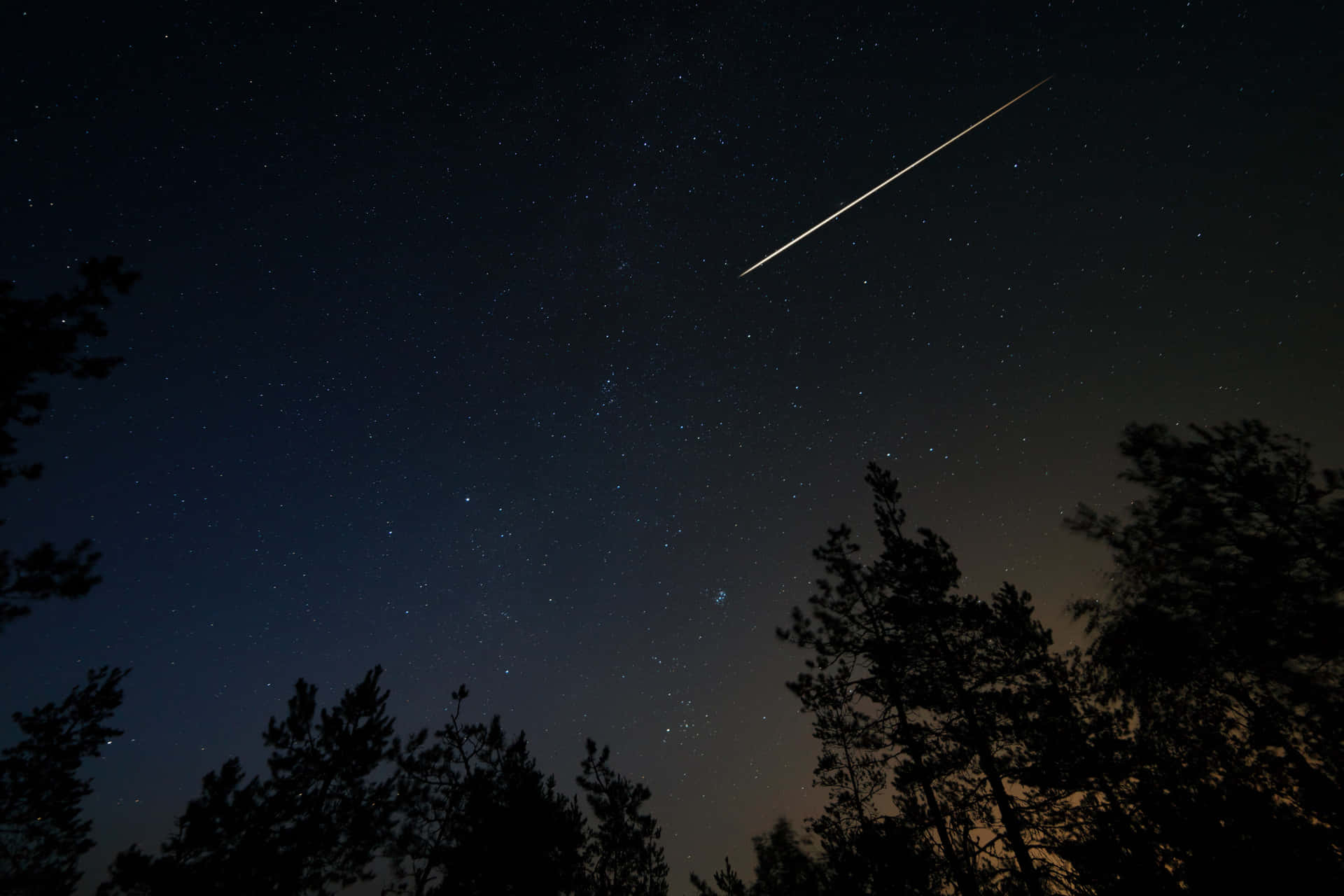 A meteor streaks through the night sky
