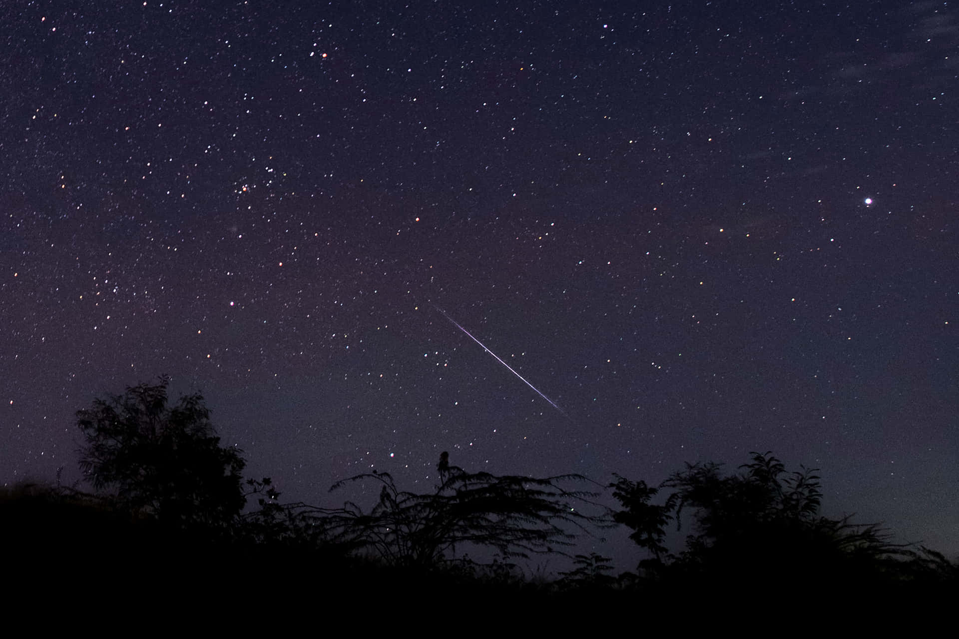Meteor streaks across night sky