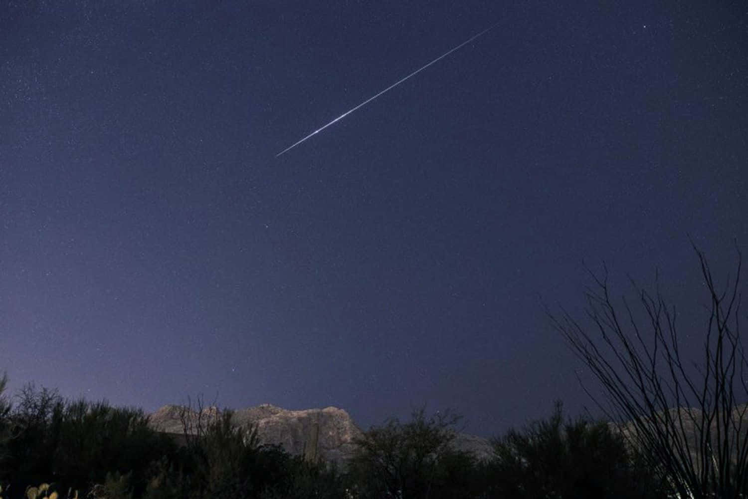 A brilliant night sky filled with a colorful meteor shower