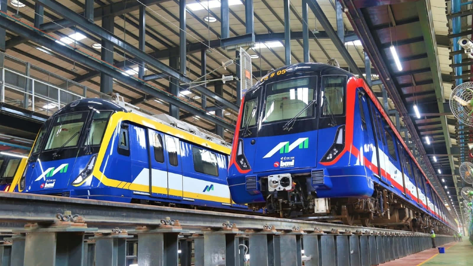 Two Blue And Yellow Trains In A Factory