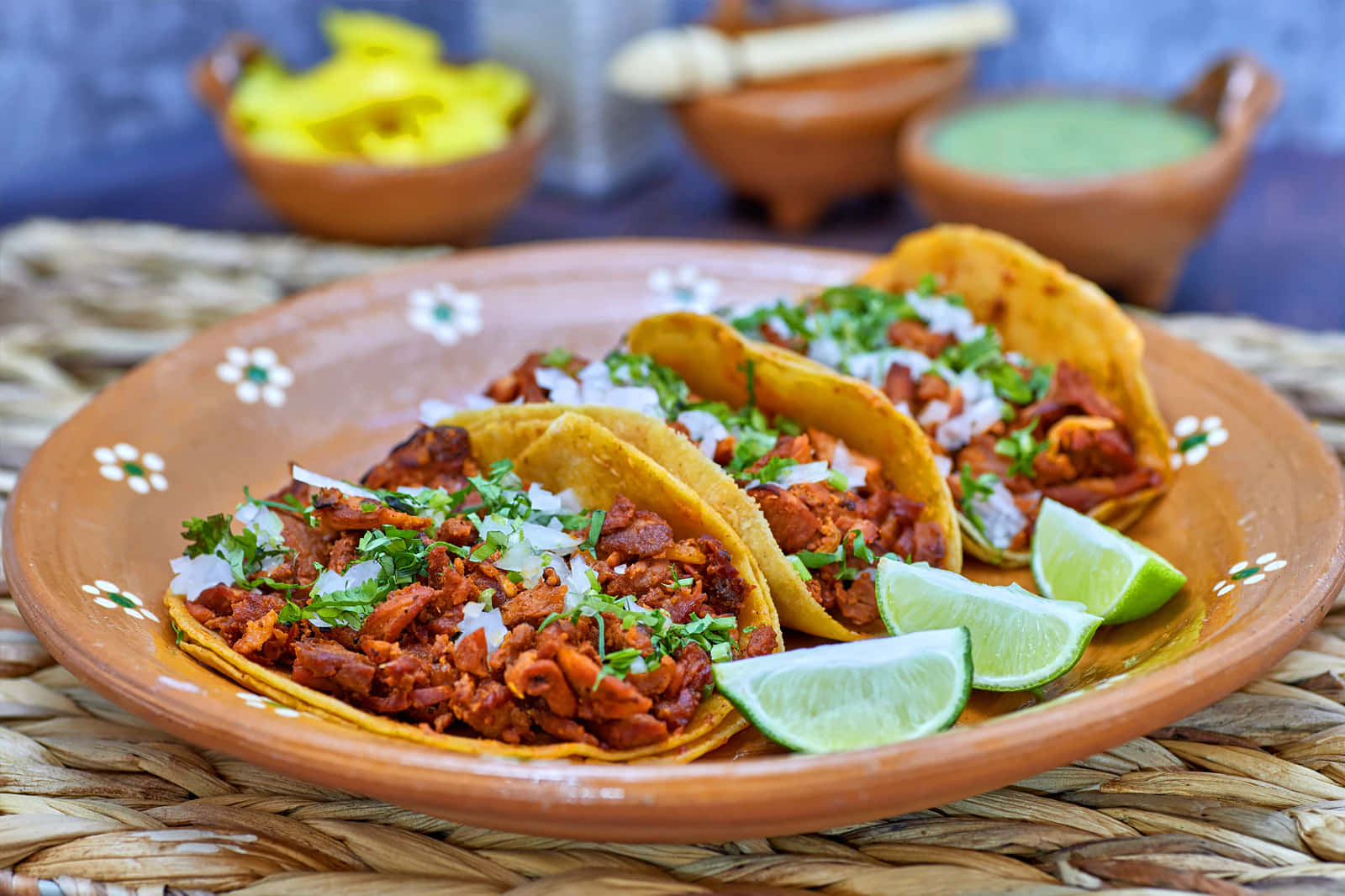 Three Tacos On A Plate With Lime Wedges