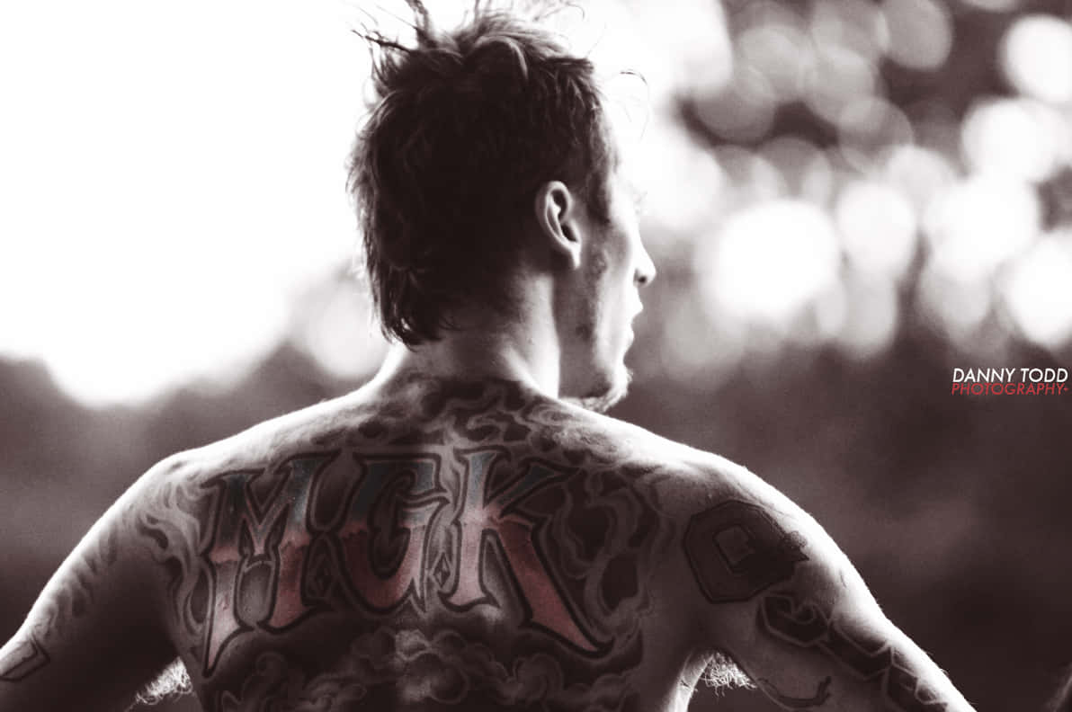 Download Mgk On His Back Wallpaper | Wallpapers.com