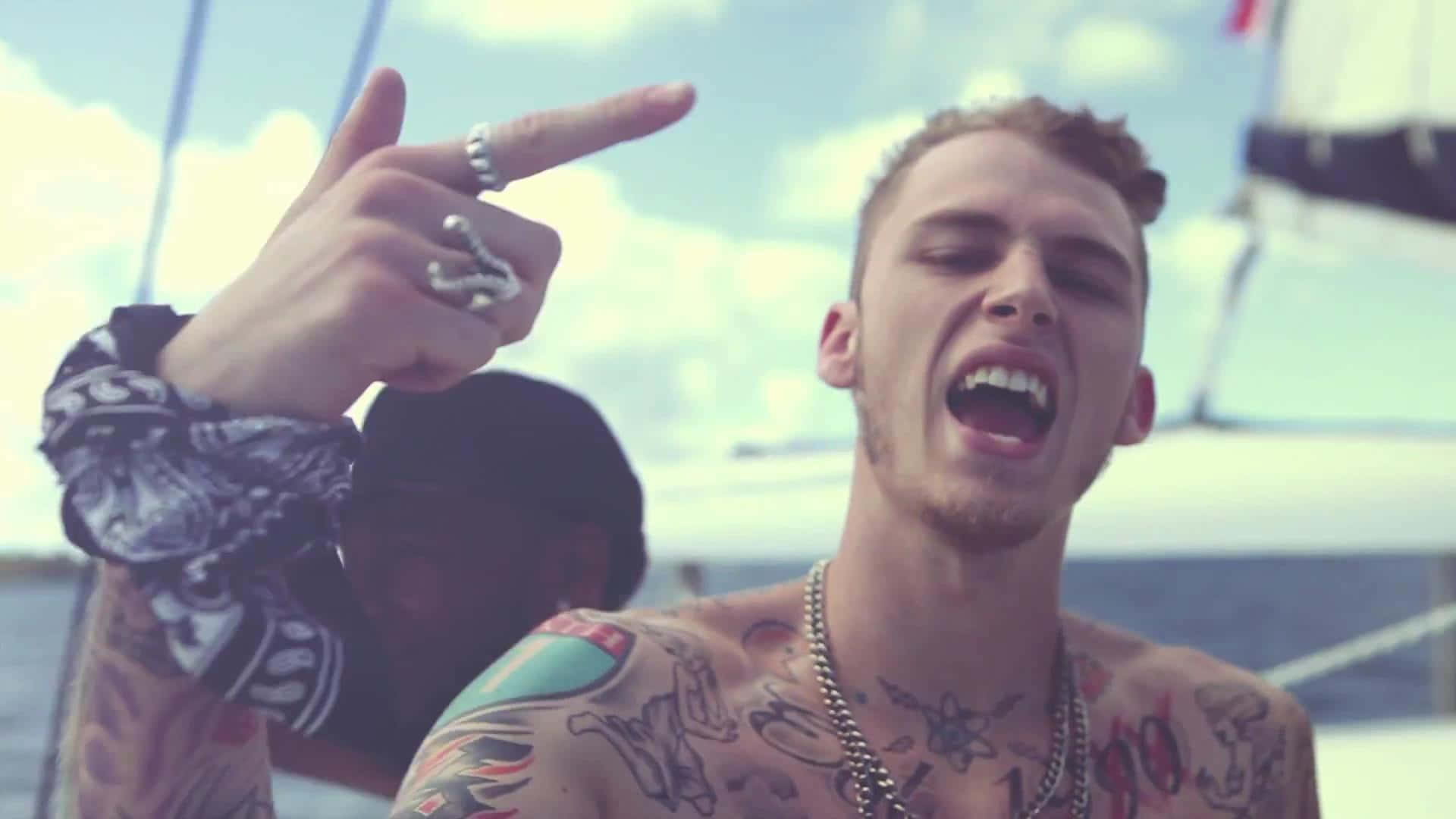Multi talented artist MGK performing for an adoring crowd Wallpaper