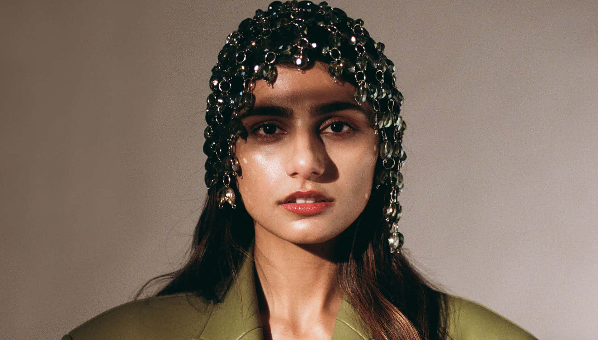 A Woman In A Green Jacket With A Headband