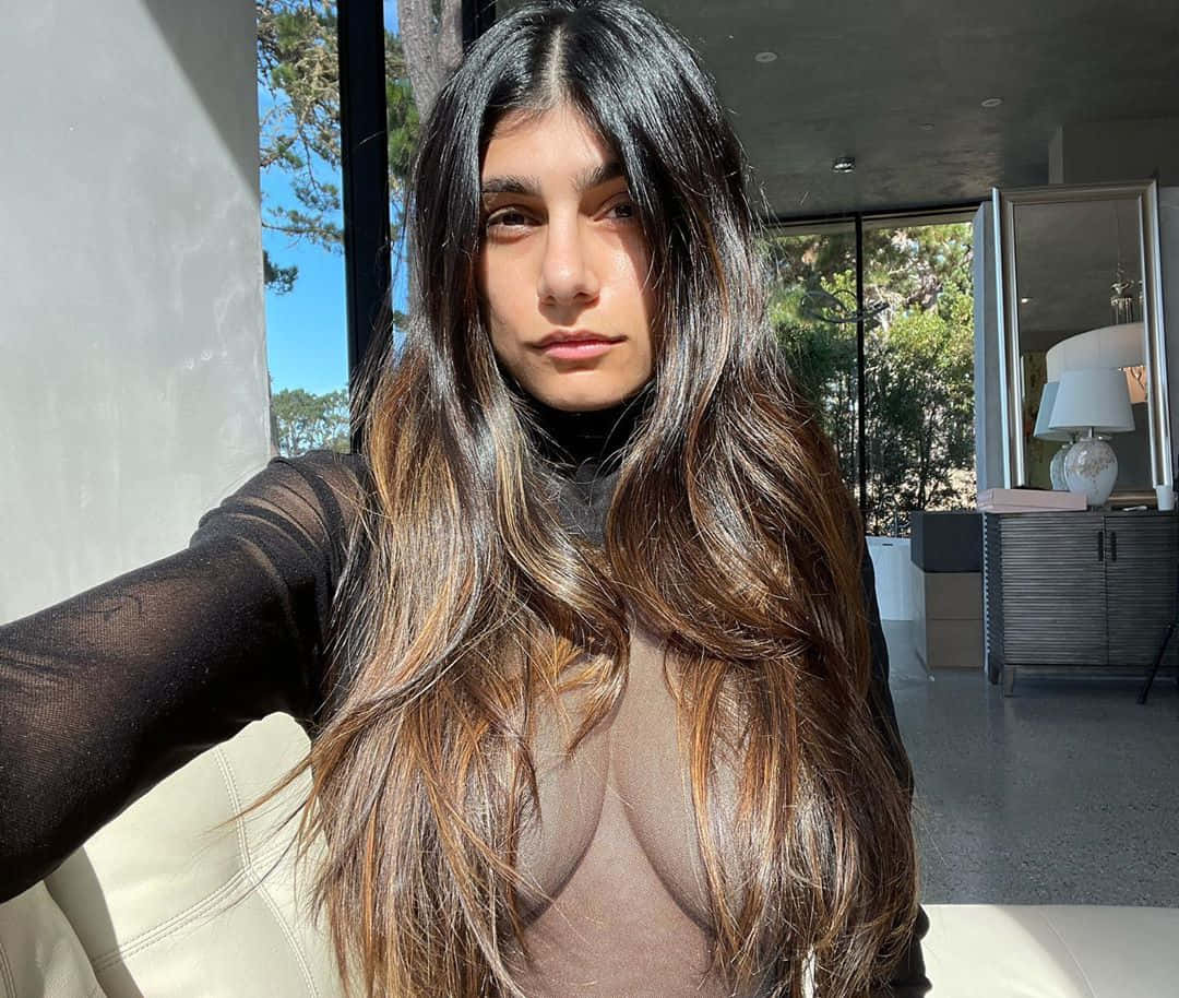 A Woman In A Sheer Top And A Long Hair
