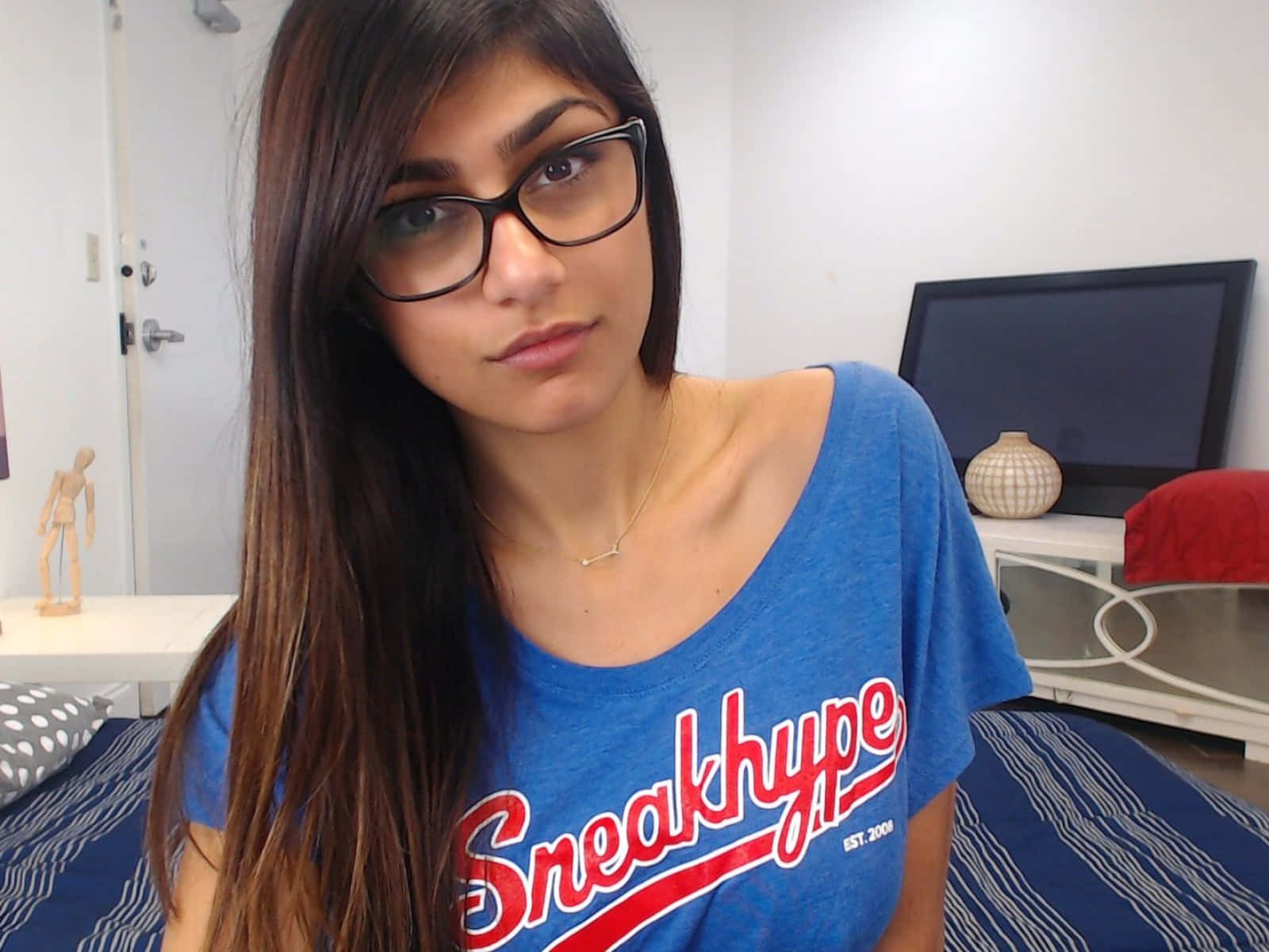 A Girl Wearing Glasses And A Blue Shirt