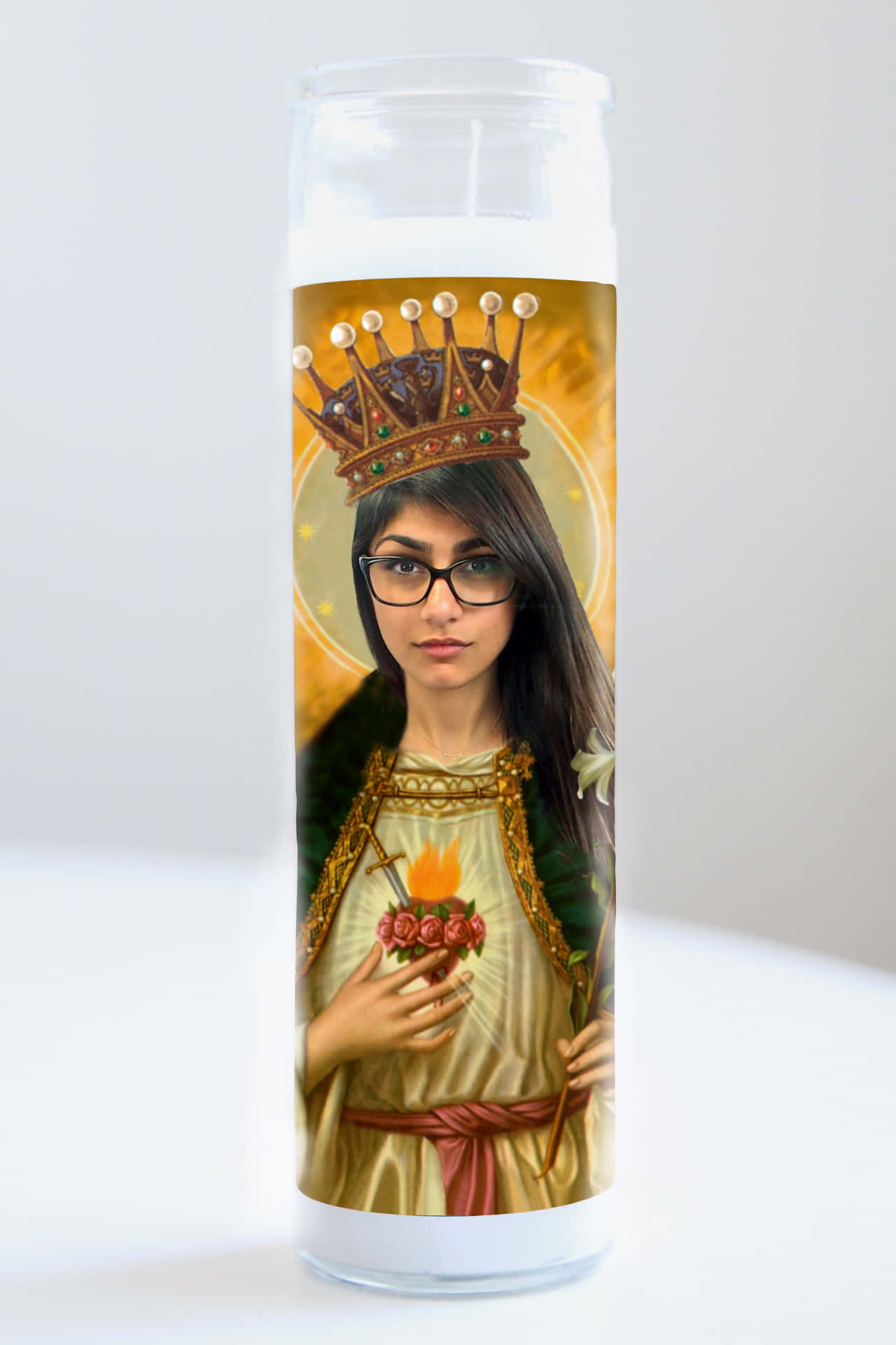 A Candle With A Picture Of A Woman Holding A Crown