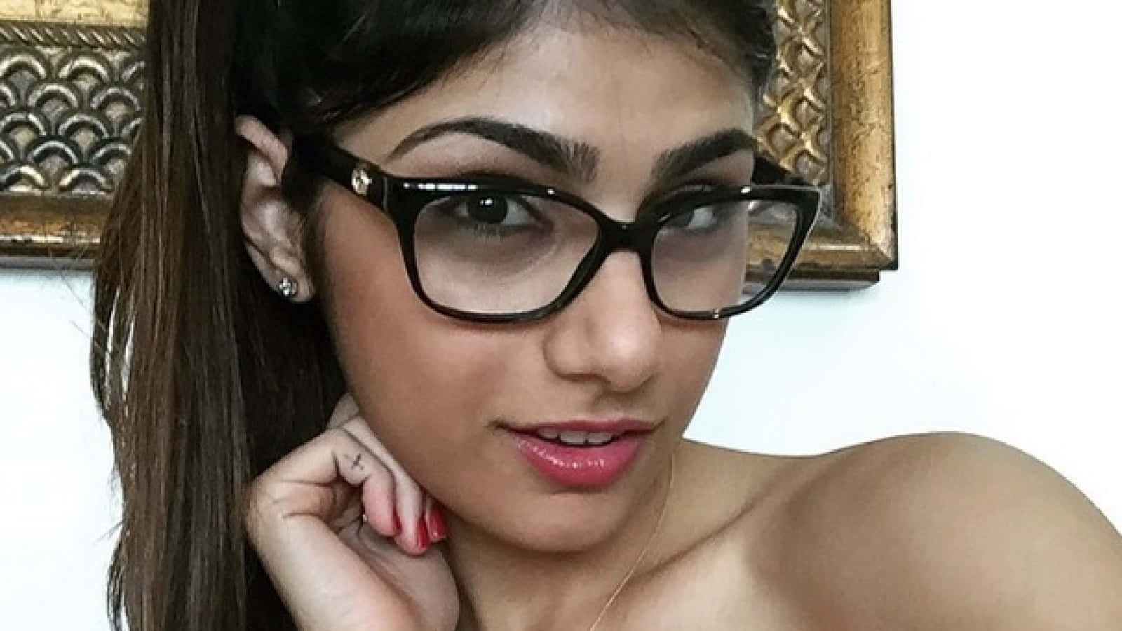 A Young Woman In Glasses Posing For A Photo