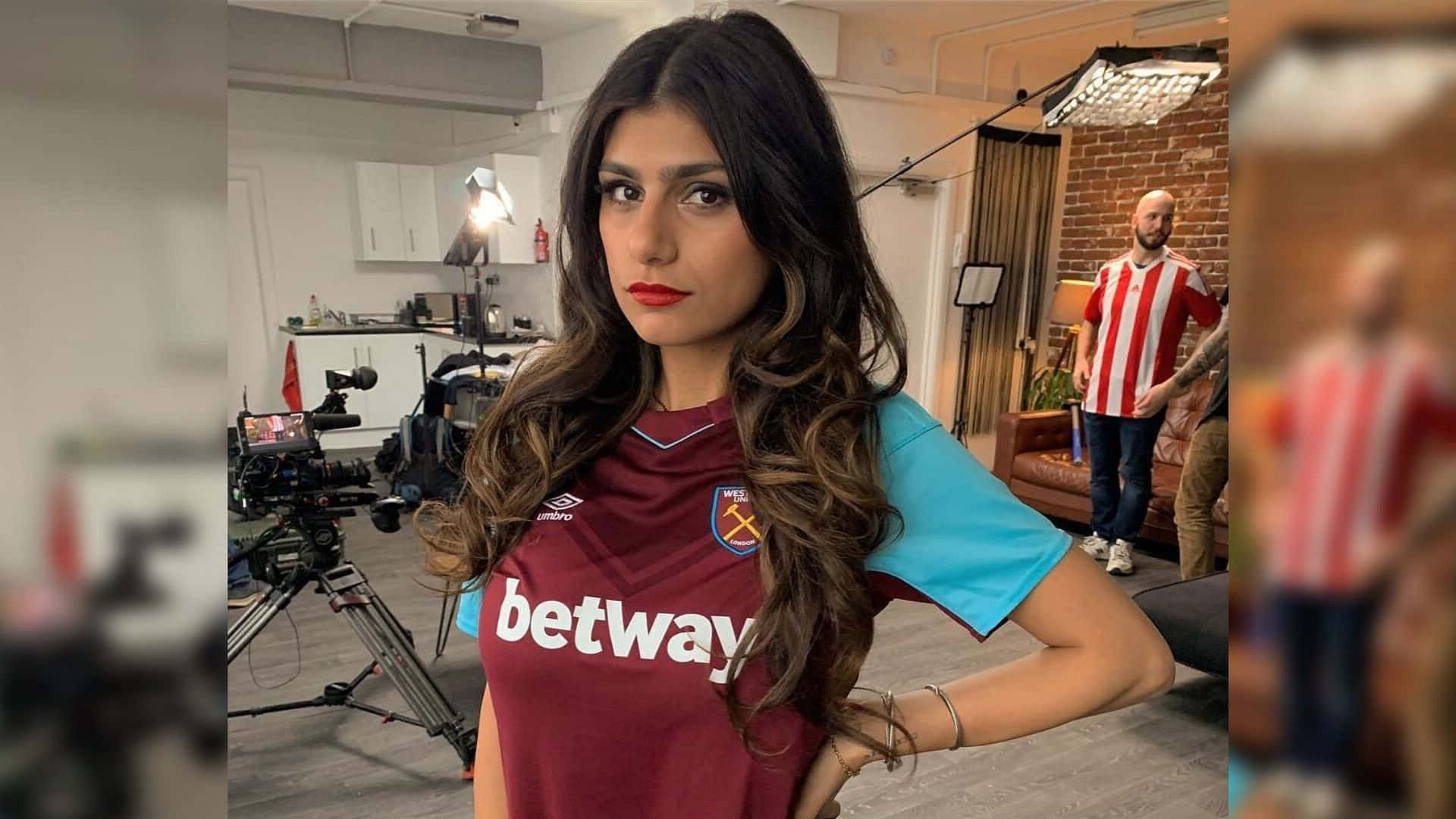 A Woman In A Soccer Jersey Posing For A Camera