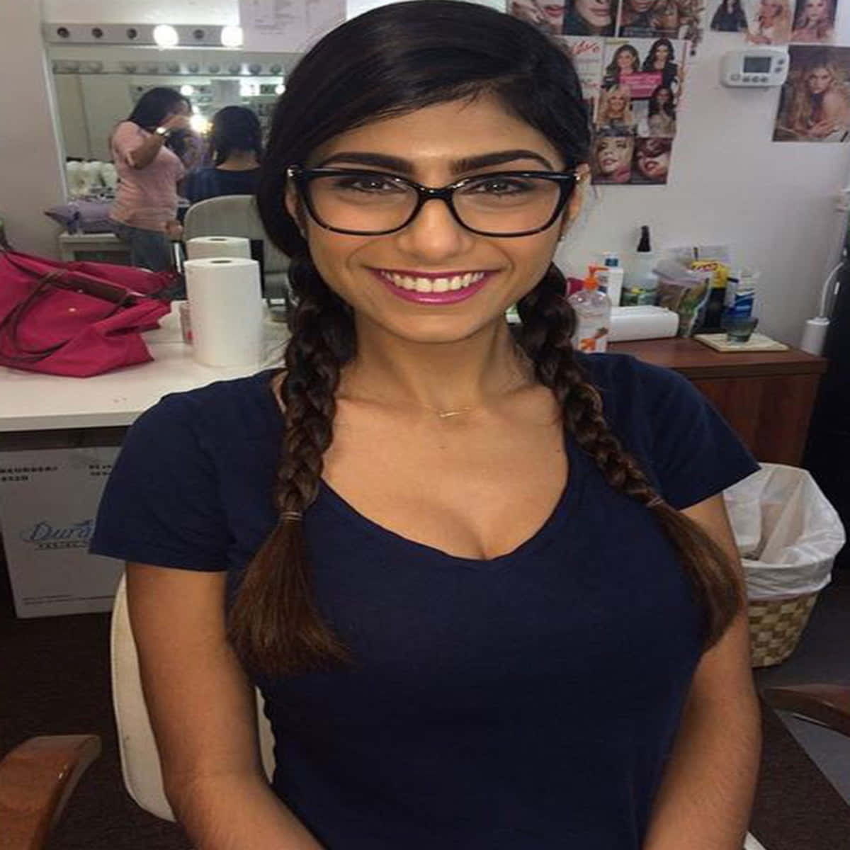 A Woman In Glasses Is Smiling In A Salon