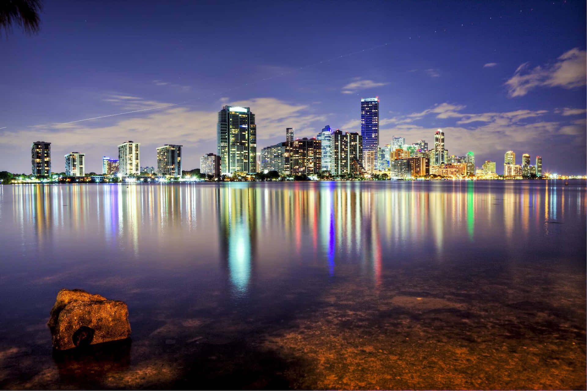 A City Skyline Is Reflected In The Water