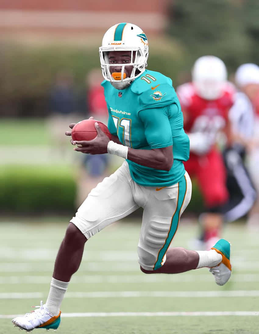 Miami Dolphins Player Running With Football Wallpaper