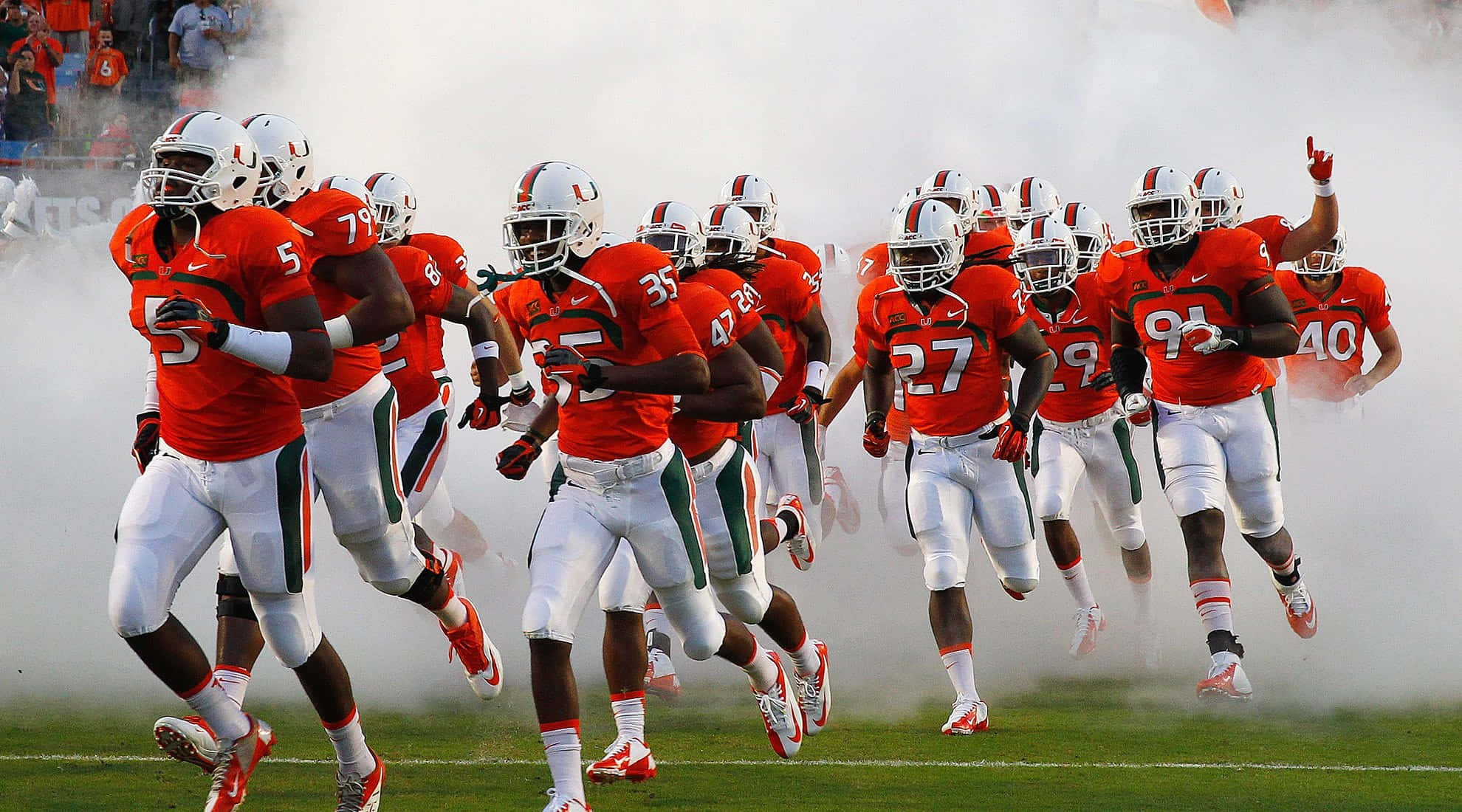 Miami Hurricanes Players On Field Wallpaper