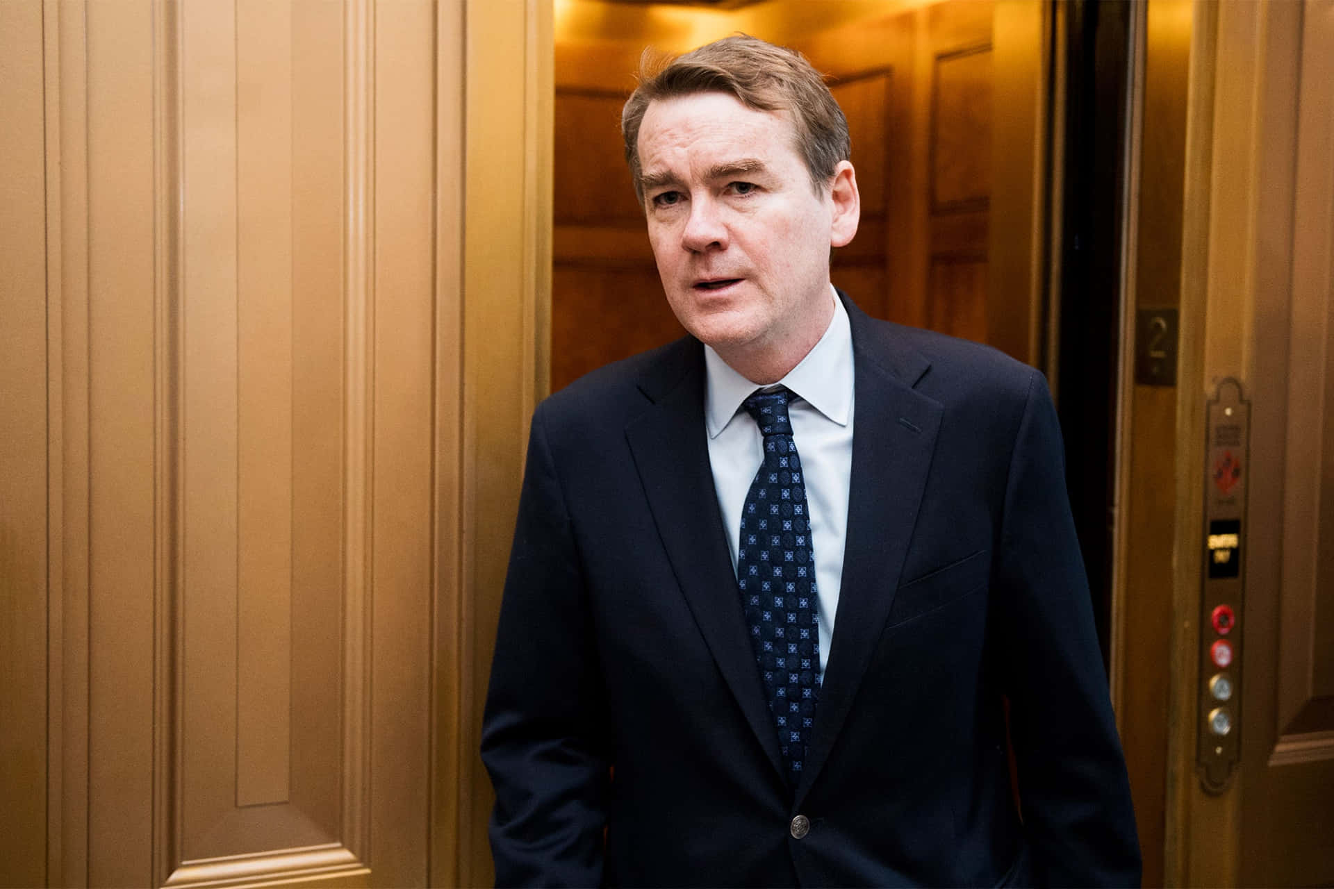 Democratic Presidential Candidate Michael Bennet Leans on Wall Wallpaper
