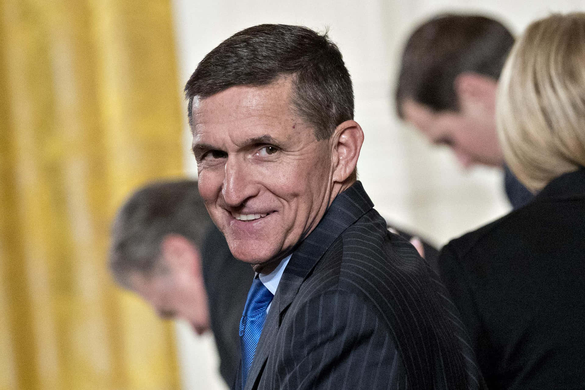 Michael Flynn Smiling Over Shoulder Wallpaper