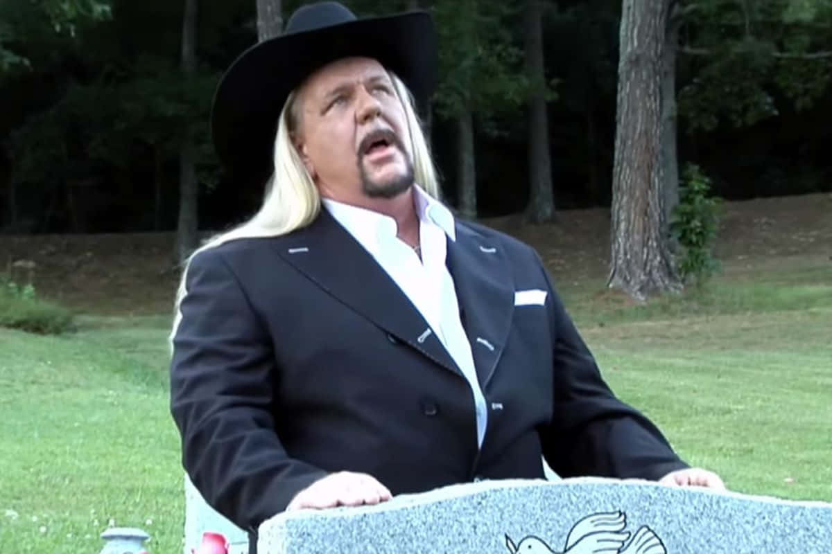 Michael Hayes Talking At A Funeral Wallpaper