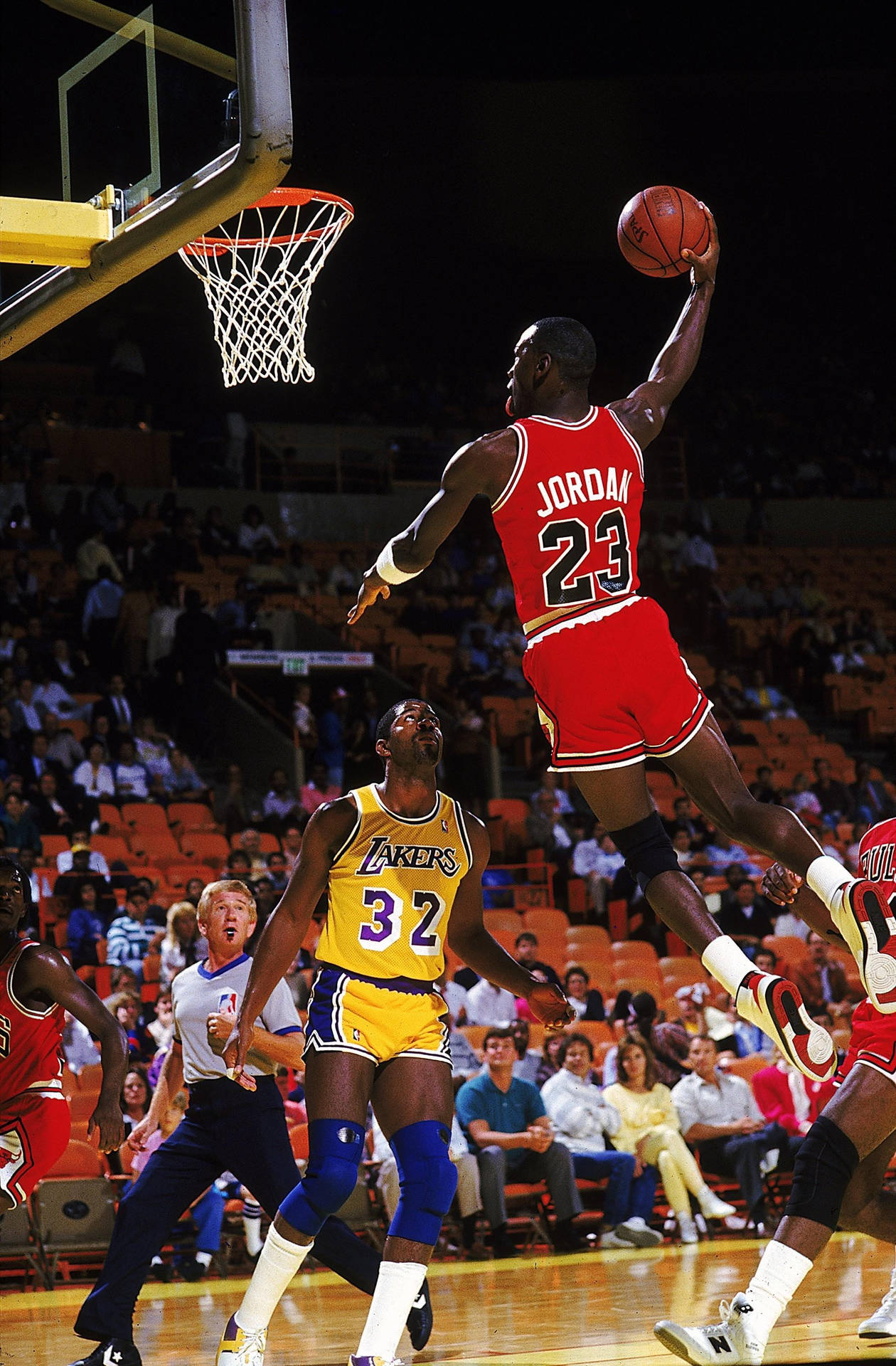 Legendary Michael Jordan showcases his iconic slam dunk Wallpaper
