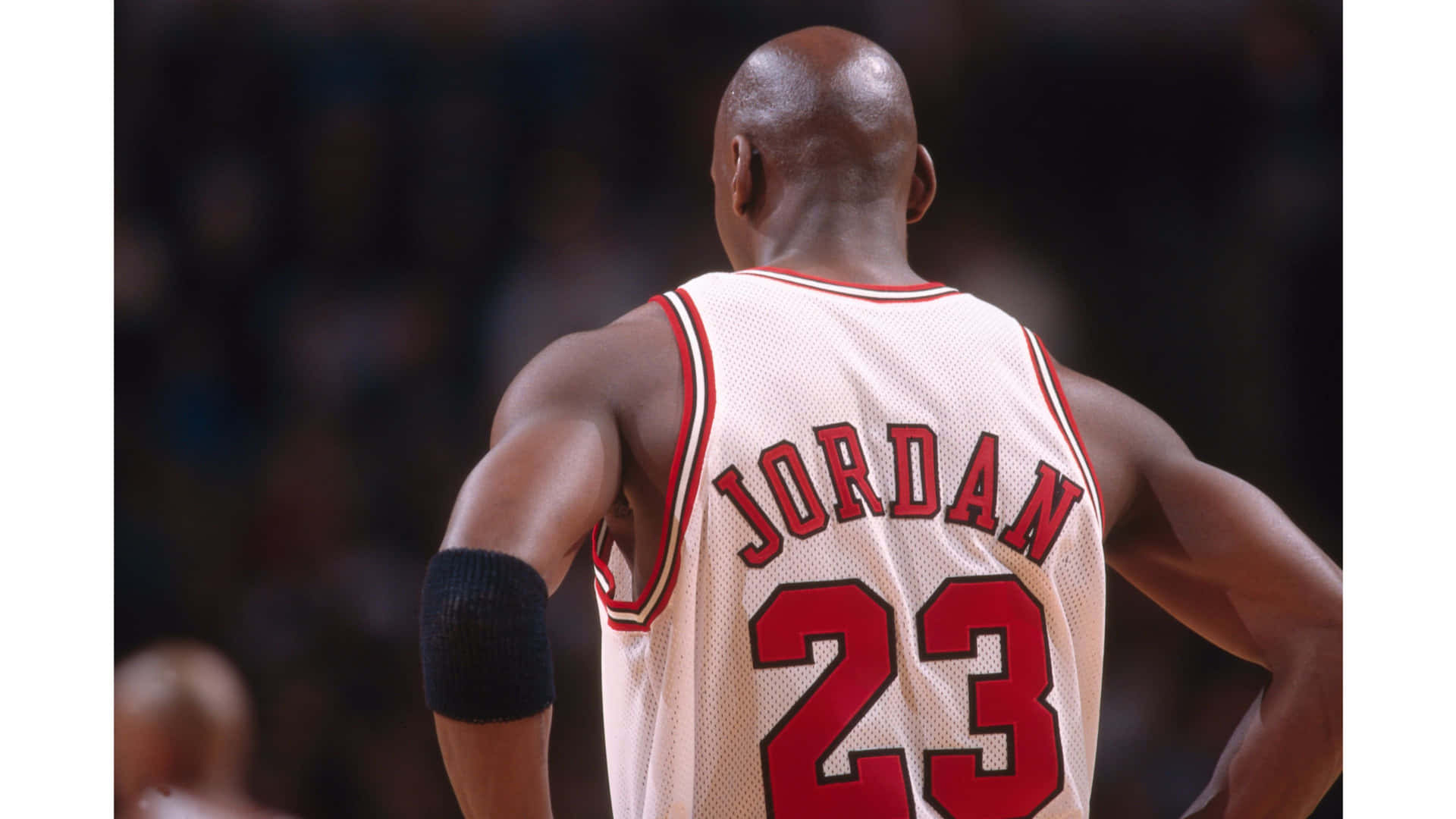Download An iconic Michael Jordan jersey hangs off a basketball