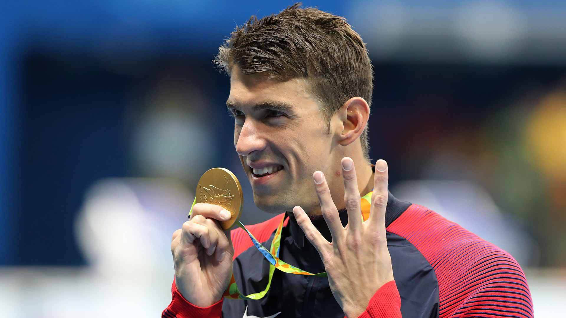Michael Phelps Displaying Four Victory Signs After Winning Wallpaper