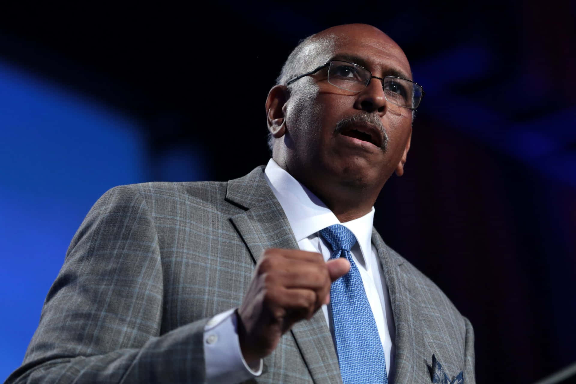 Michael Steele Delivering Speech On Stage Wallpaper