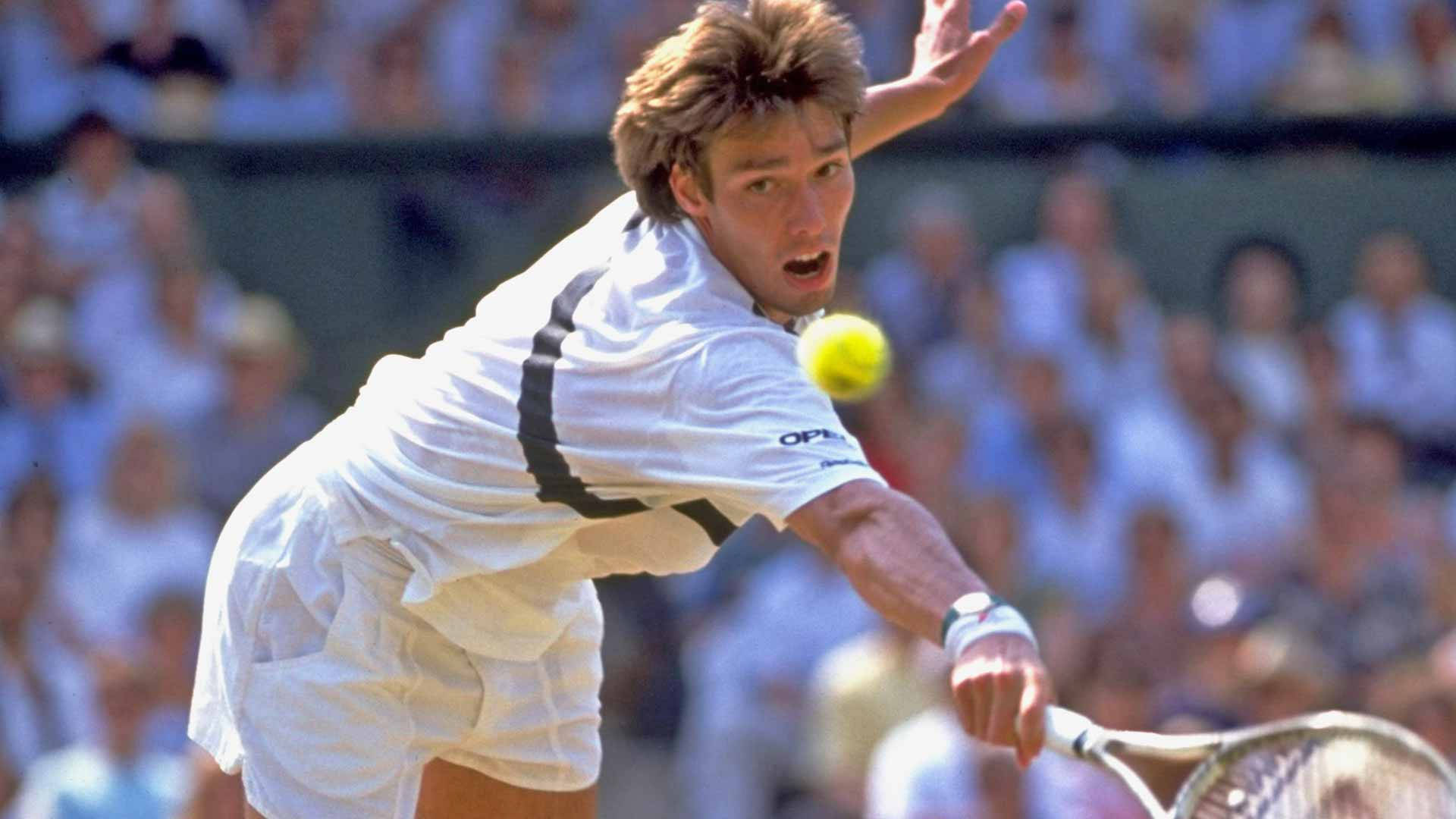Michael Stich fiercely chasing a ball during a tennis match Wallpaper