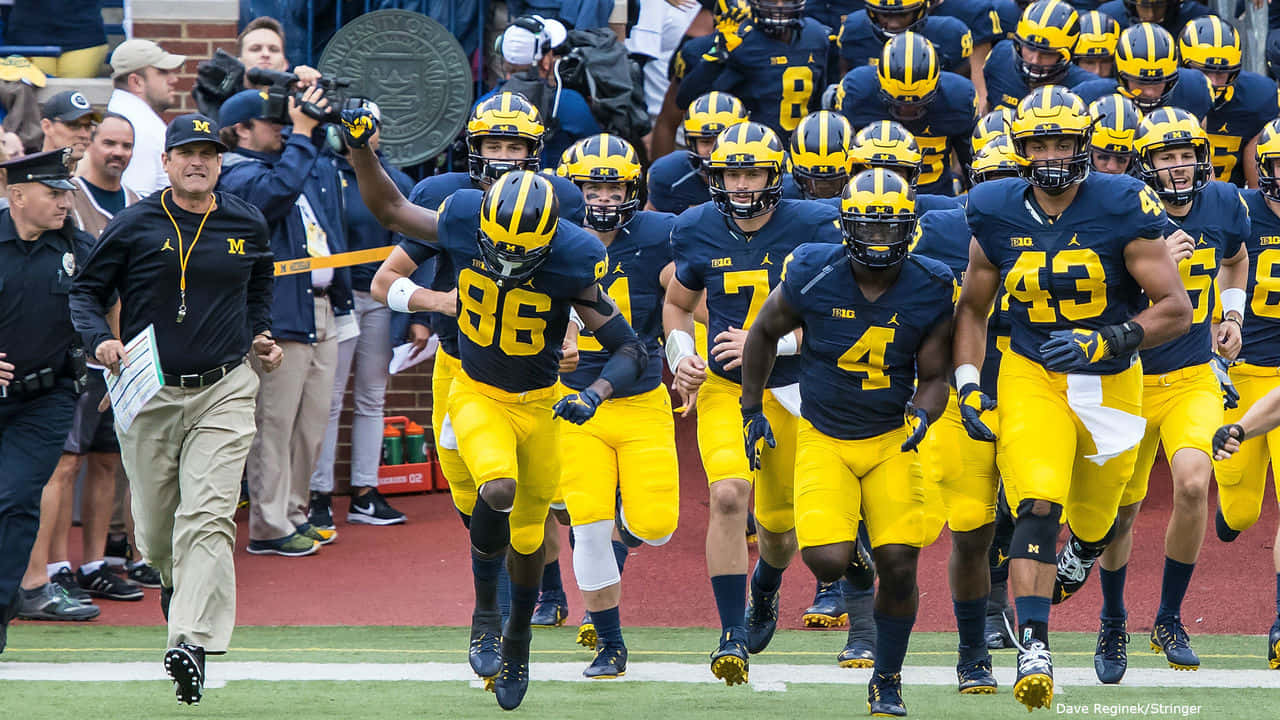 Michigan Wolverines Football Team Running Onto The Field Wallpaper