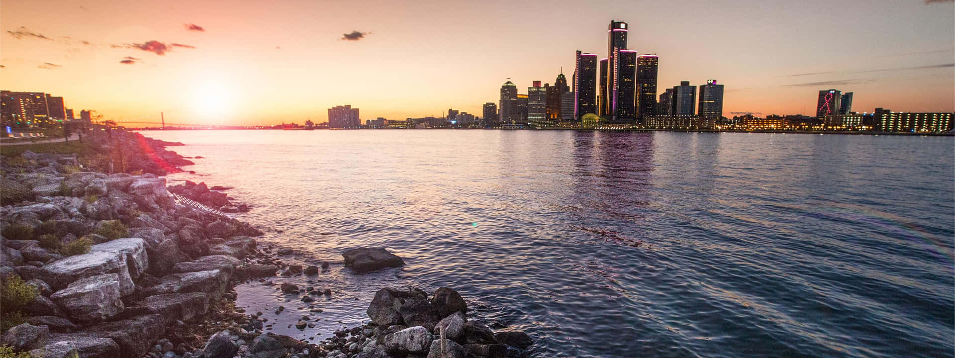 A City Skyline With A Sunset Over The Water