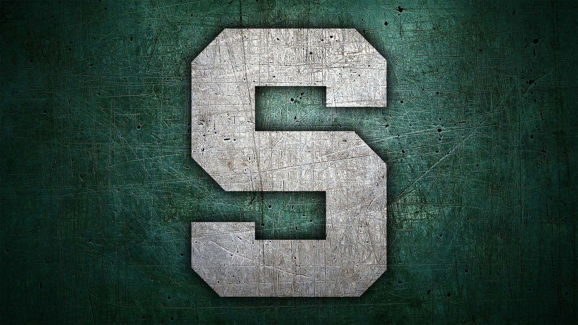 Trofaste Michigan State Spartans-fans vil elske denne fremhævede designet tapet, der fremhæver holdets ikoniske logo. Wallpaper